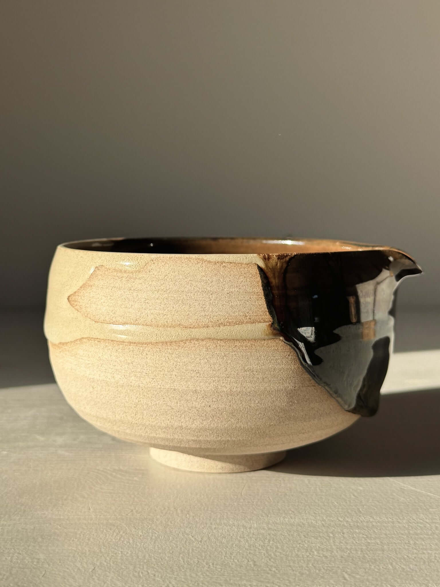 Handmade ceramic Matcha Bowl with Spout – Inyo #04 featuring tenmoku and clear glazes, wheel-thrown and unique from Inyo Series.