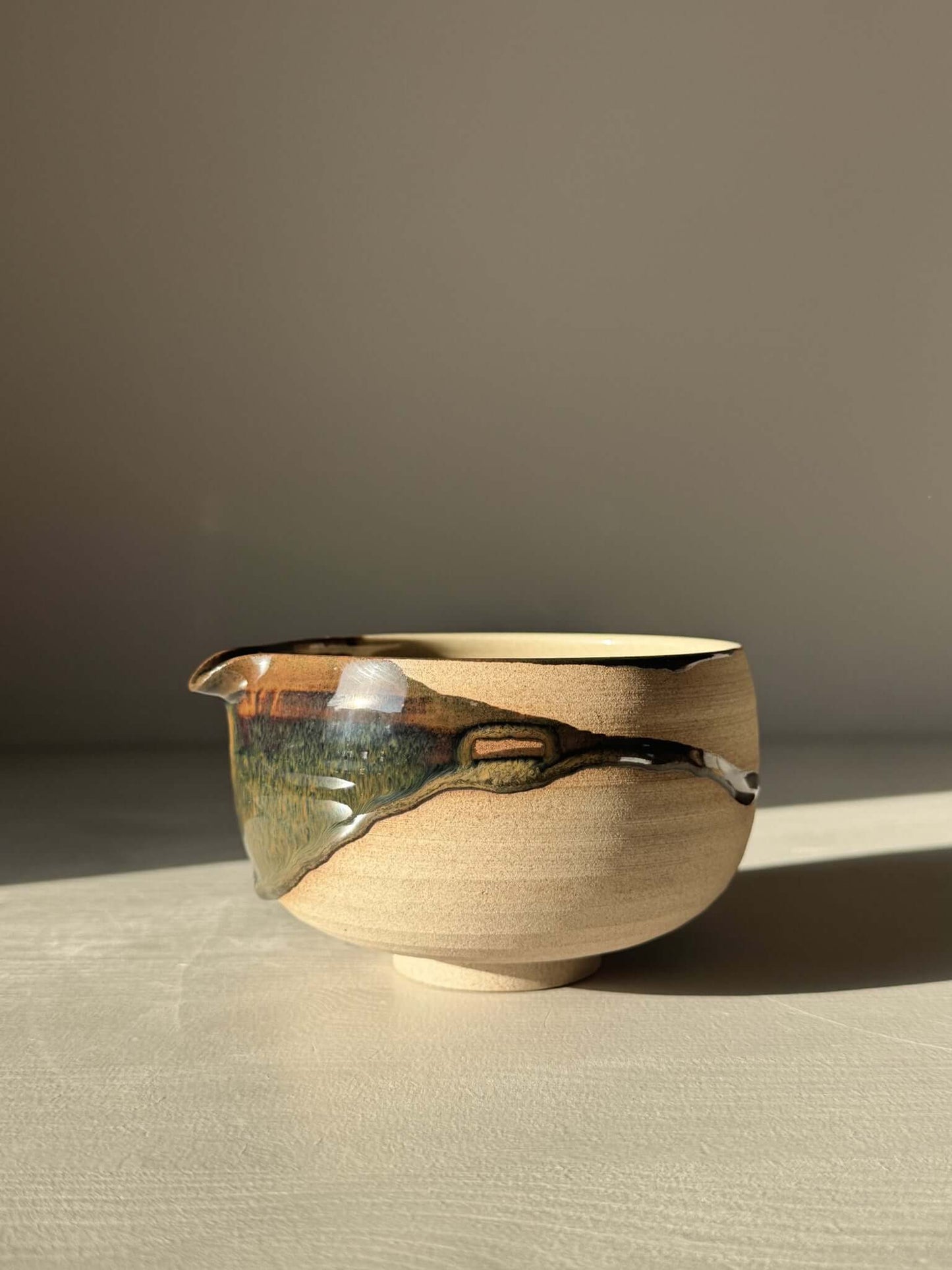 Handmade ceramic Matcha Bowl with Spout – Inyo #04 featuring unique tenmoku and clear glazes on stoneware clay.