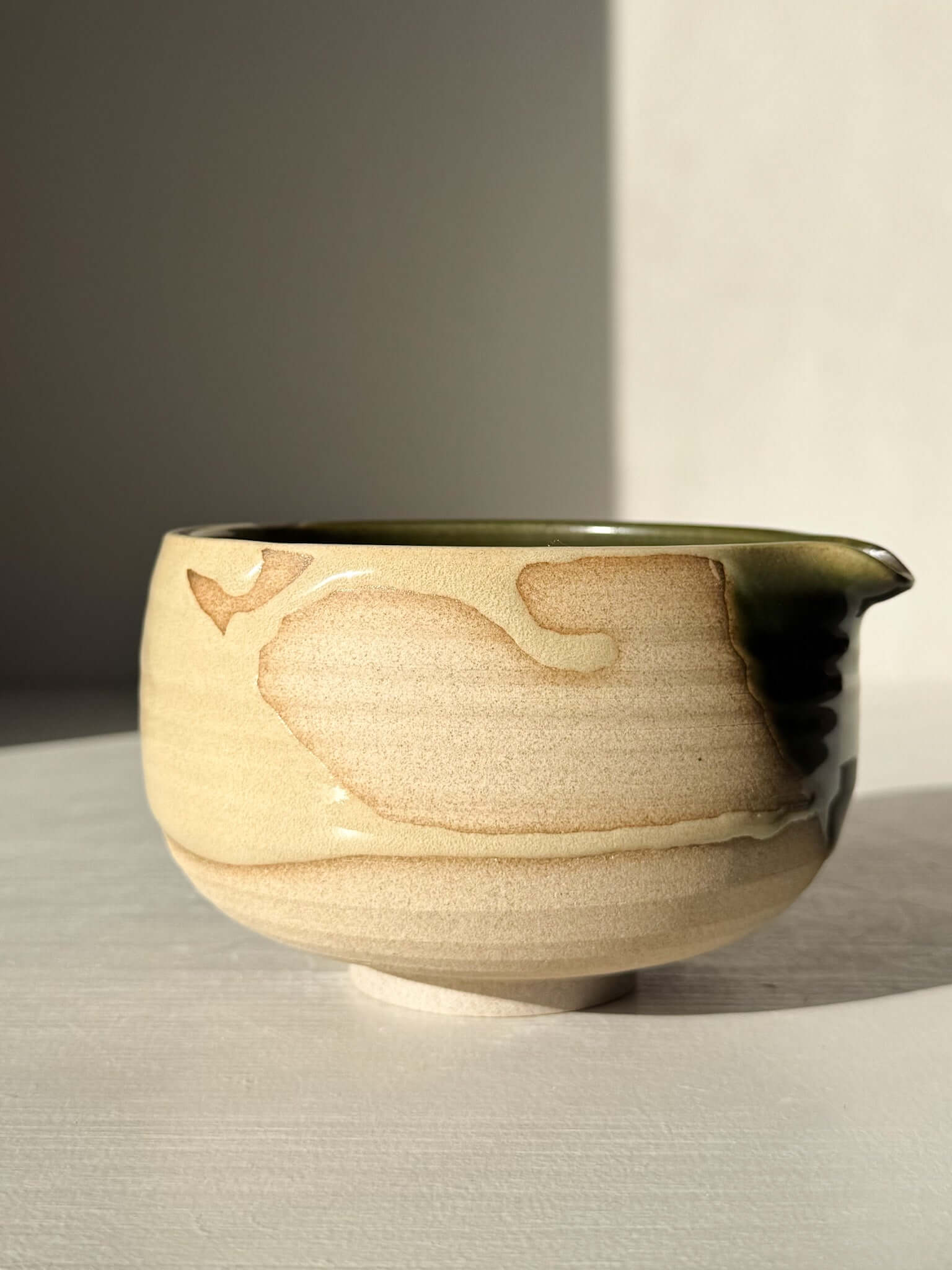 Handmade ceramic Matcha Bowl with Spout – Mori #03, featuring natural stoneware with green and brown glazes, side view.