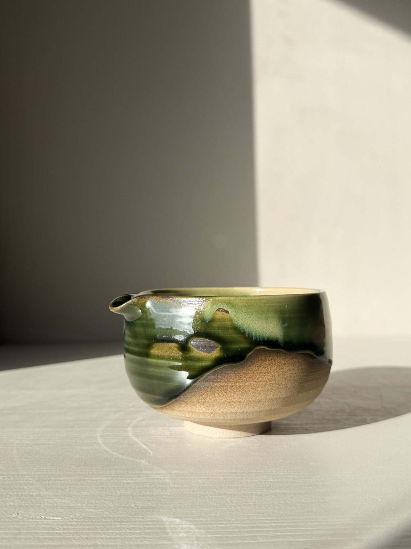 Handmade ceramic Matcha Bowl with Spout – Mori #04 featuring green and brown glaze on stoneware.