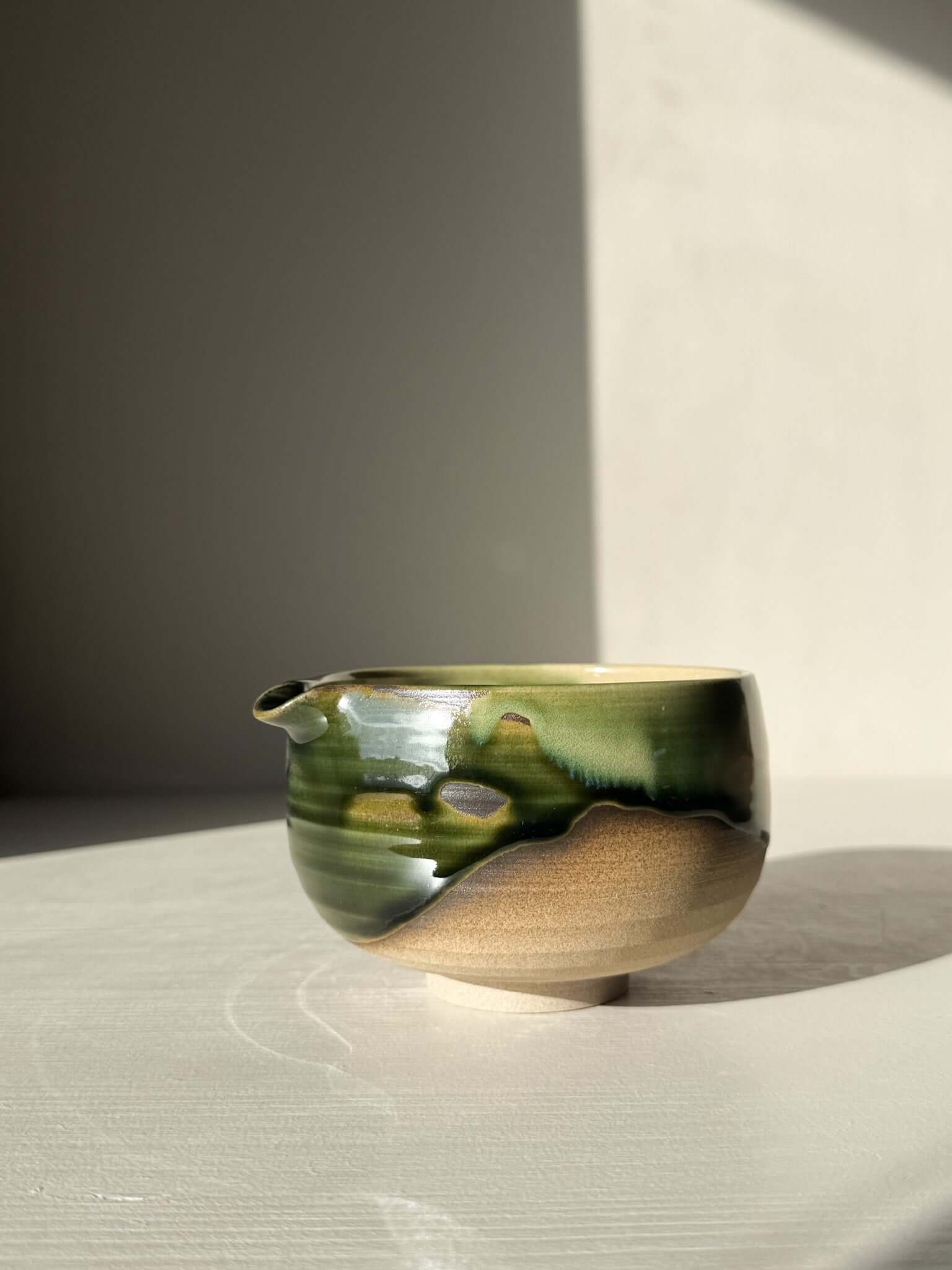 Handmade ceramic Matcha Bowl with Spout – Mori #04 featuring green and brown glaze on stoneware.