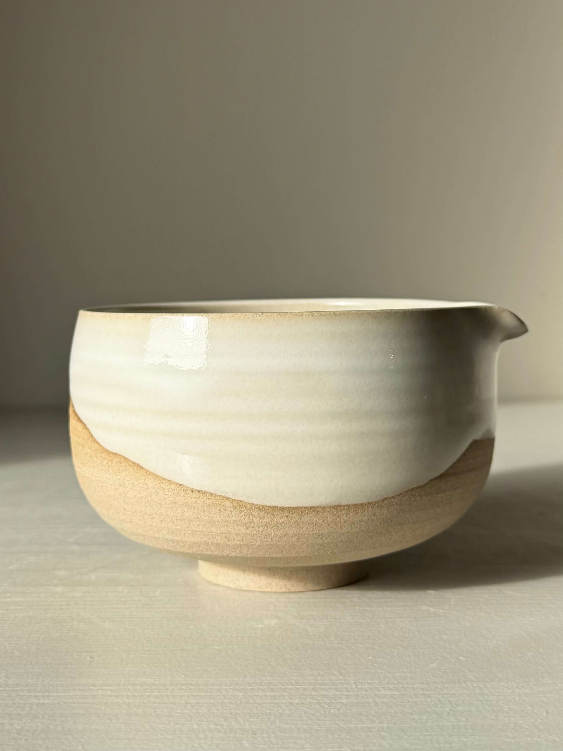 Handmade ceramic Matcha Bowl with Spout – Yuki #01 featuring toffee clay and white glaze.