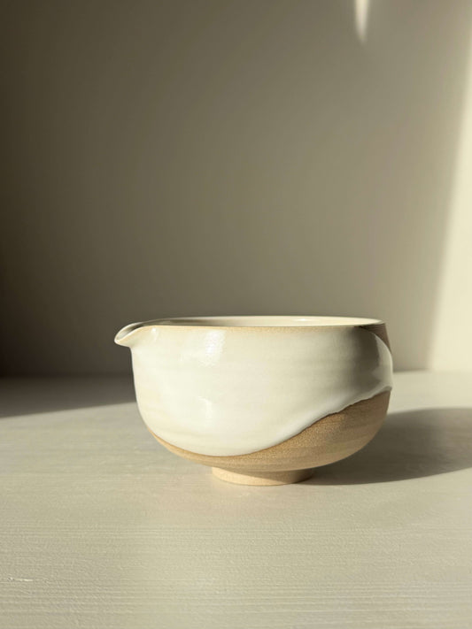 Handmade ceramic Matcha Bowl with Spout – Yuki #04 in toffee clay and white glaze, showcasing unique natural drip patterns.