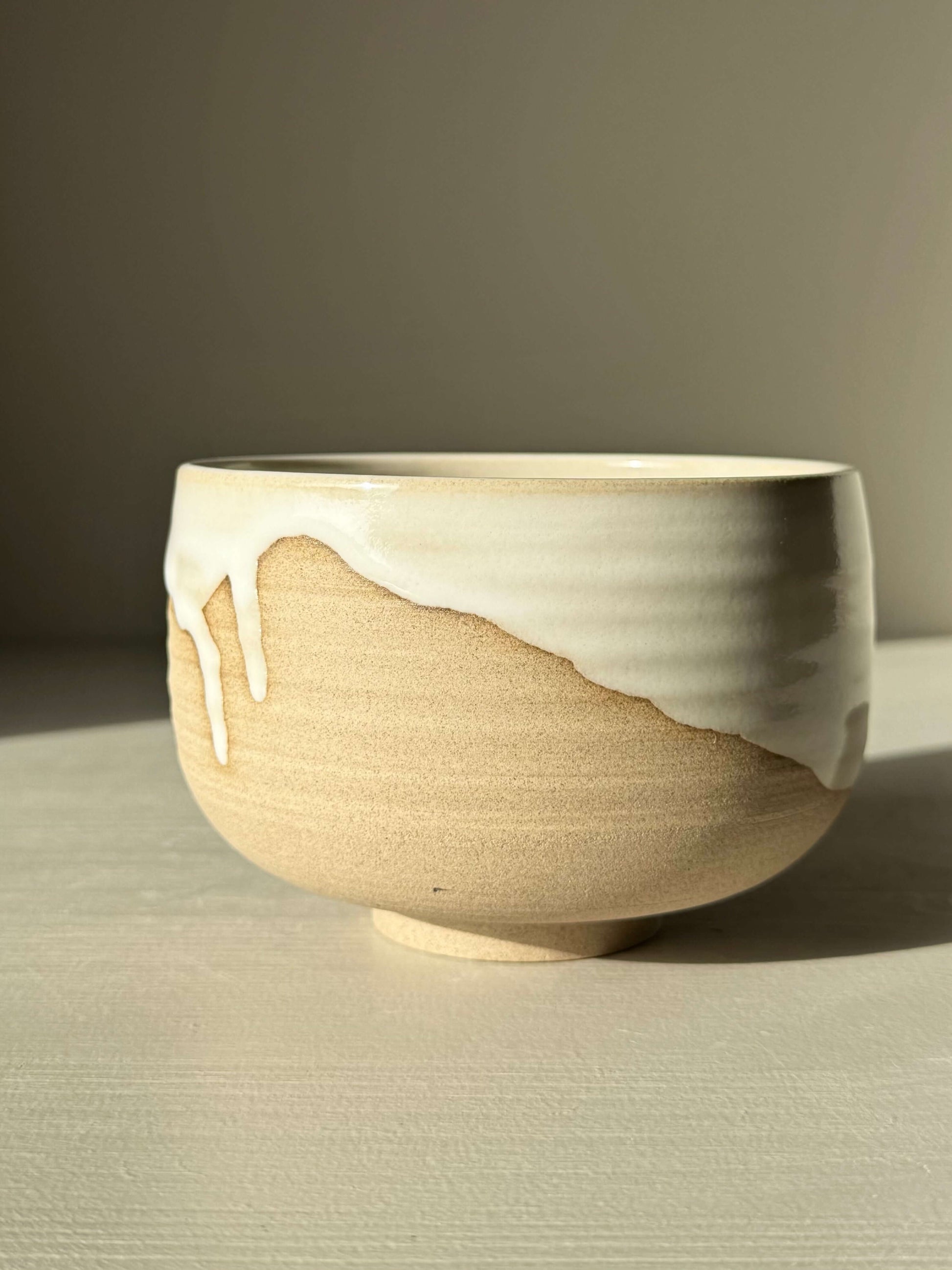 Handmade ceramic Matcha Bowl – Yuki #01 with toffee clay and white glaze drips, crafted in home studio. Unique artisanal design.