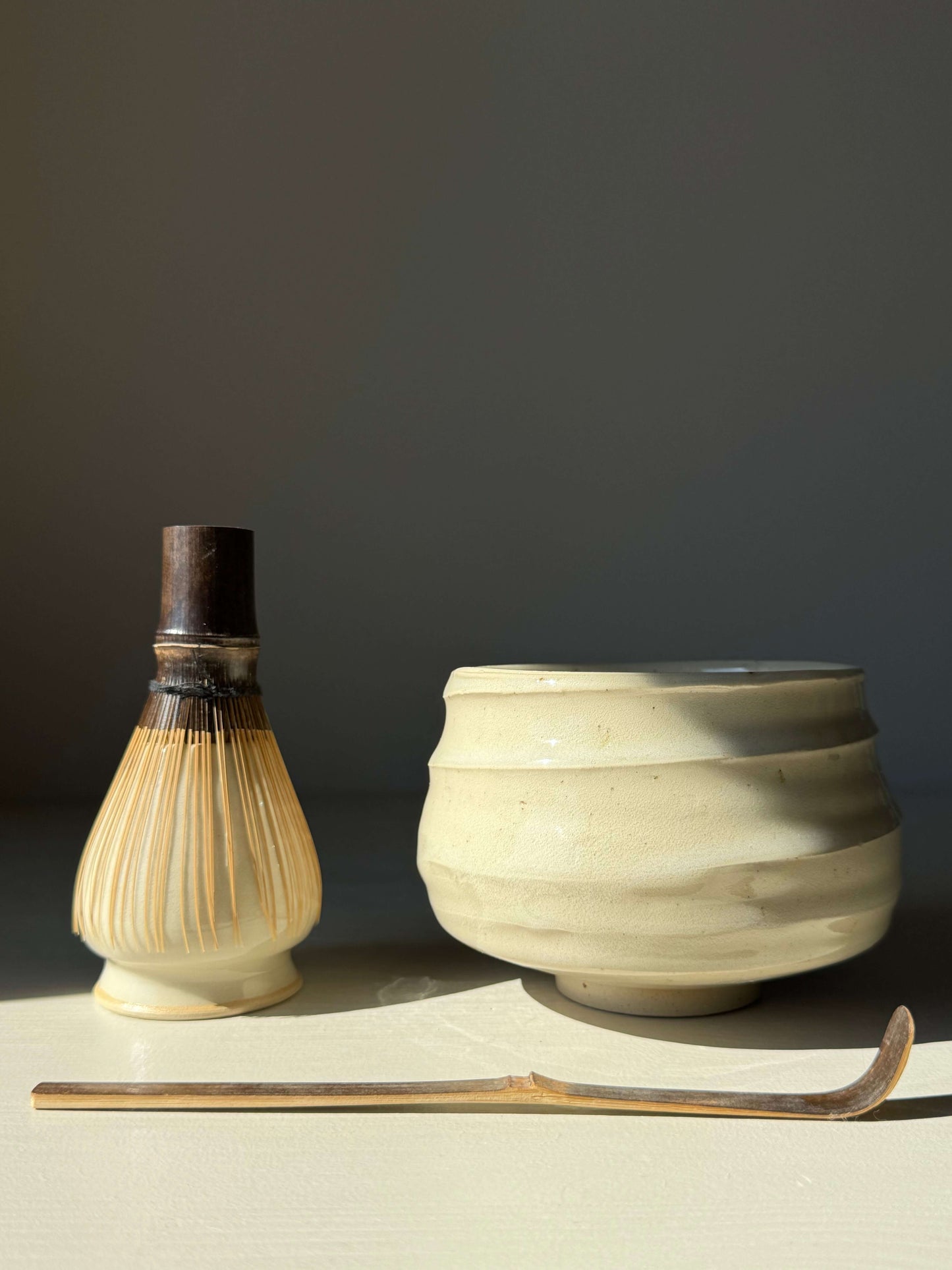 Handmade ceramic Matcha Whisk Holder - Clear Glaze with whisk and bowl on display