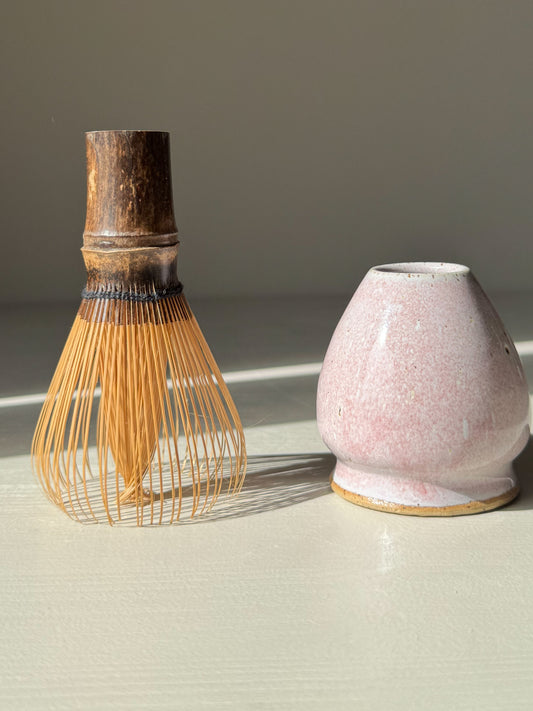 Matcha Whisk Holder - Pale Pink with handmade ceramic design and bamboo whisk, adding elegance to tea setups with its soft, unique glaze.