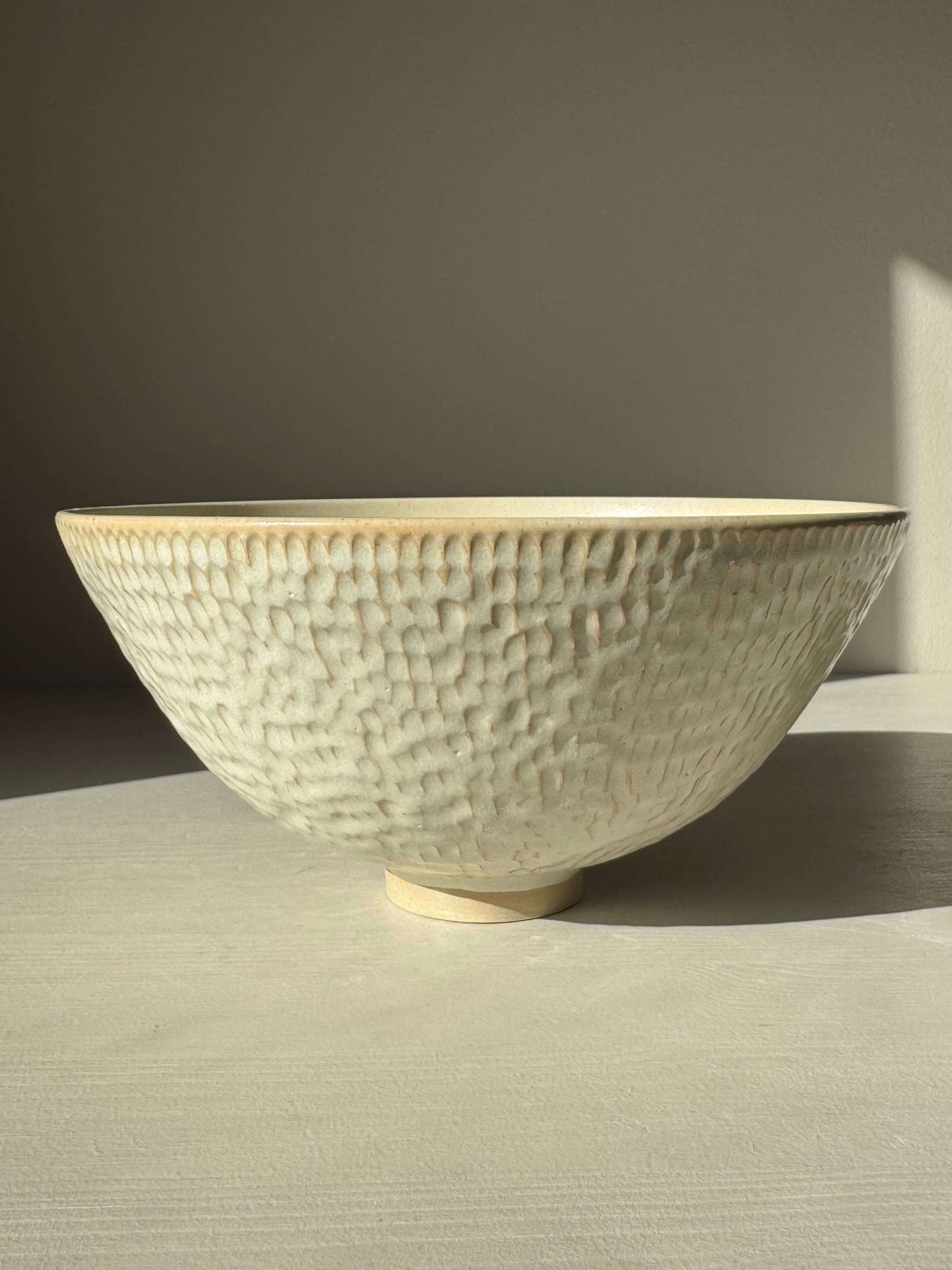 Handmade ceramic Medium Bowl – Moonstone with satin finish and textured surface in soft lighting.