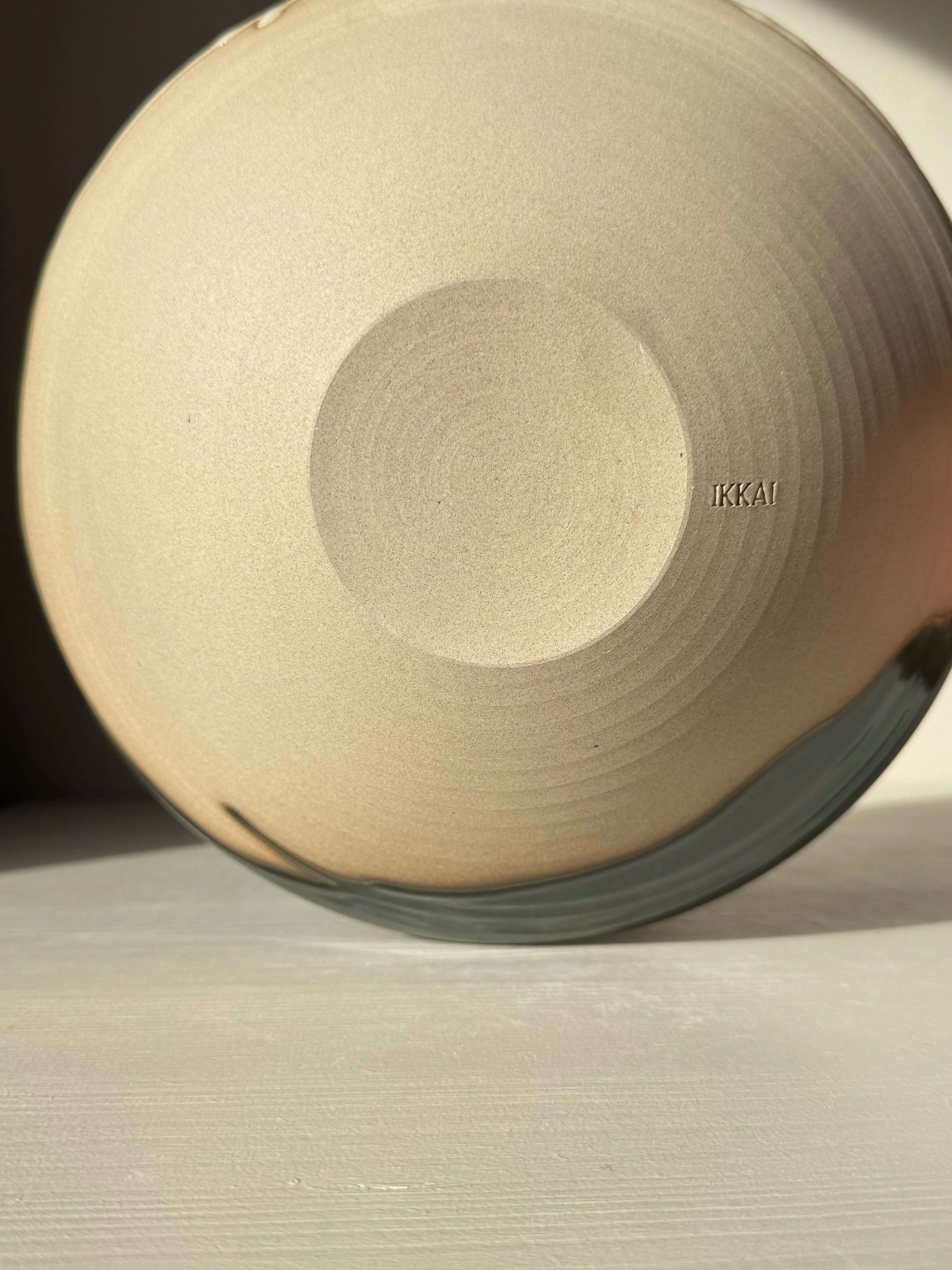 Bottom view of Medium Bowl - Mori #01 handmade ceramic with raw toffee clay and green glaze.