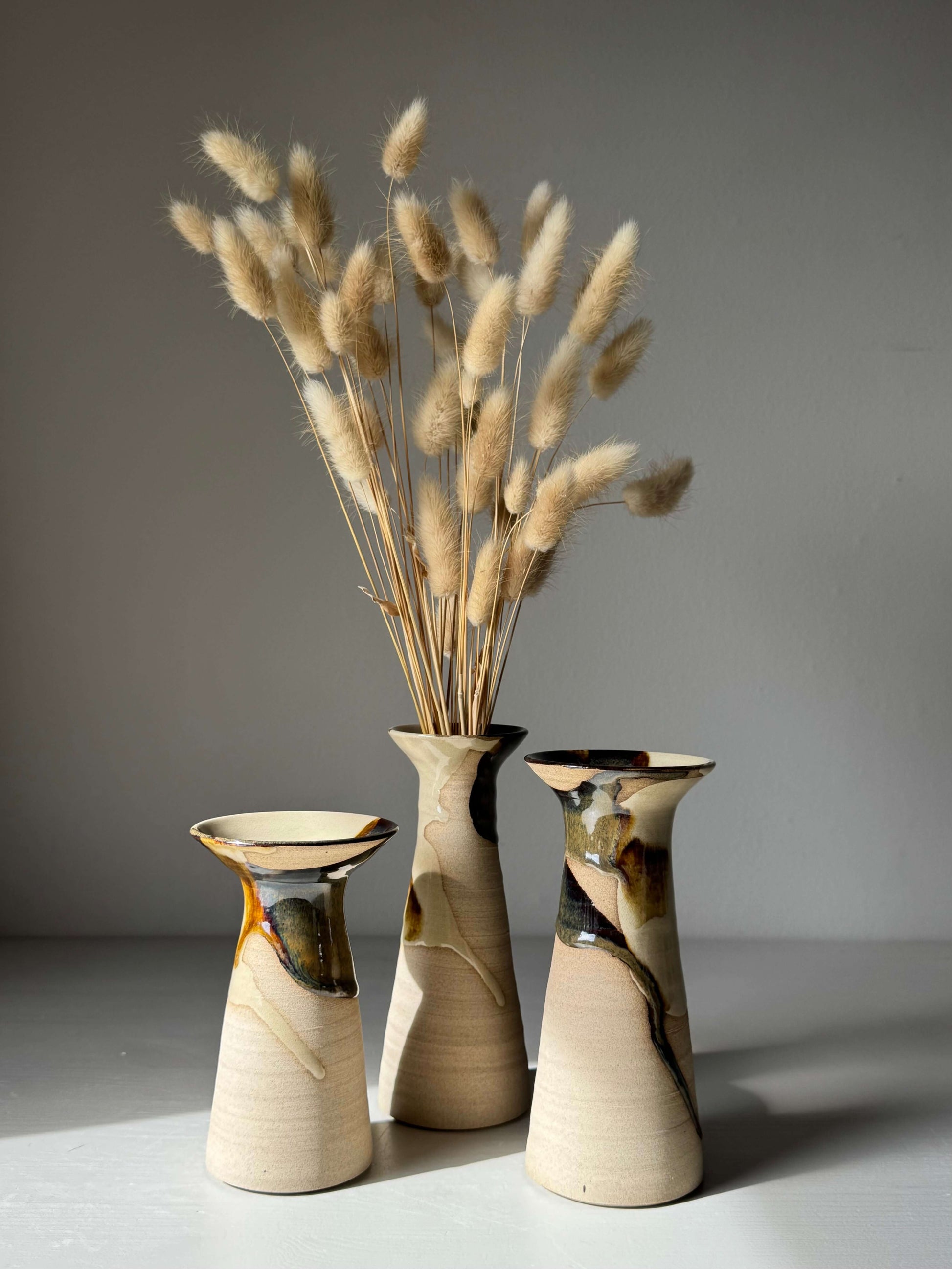 Medium Vase – Inyo Series #03 handmade ceramic with unique glaze next to dried botanicals in a softly lit studio
