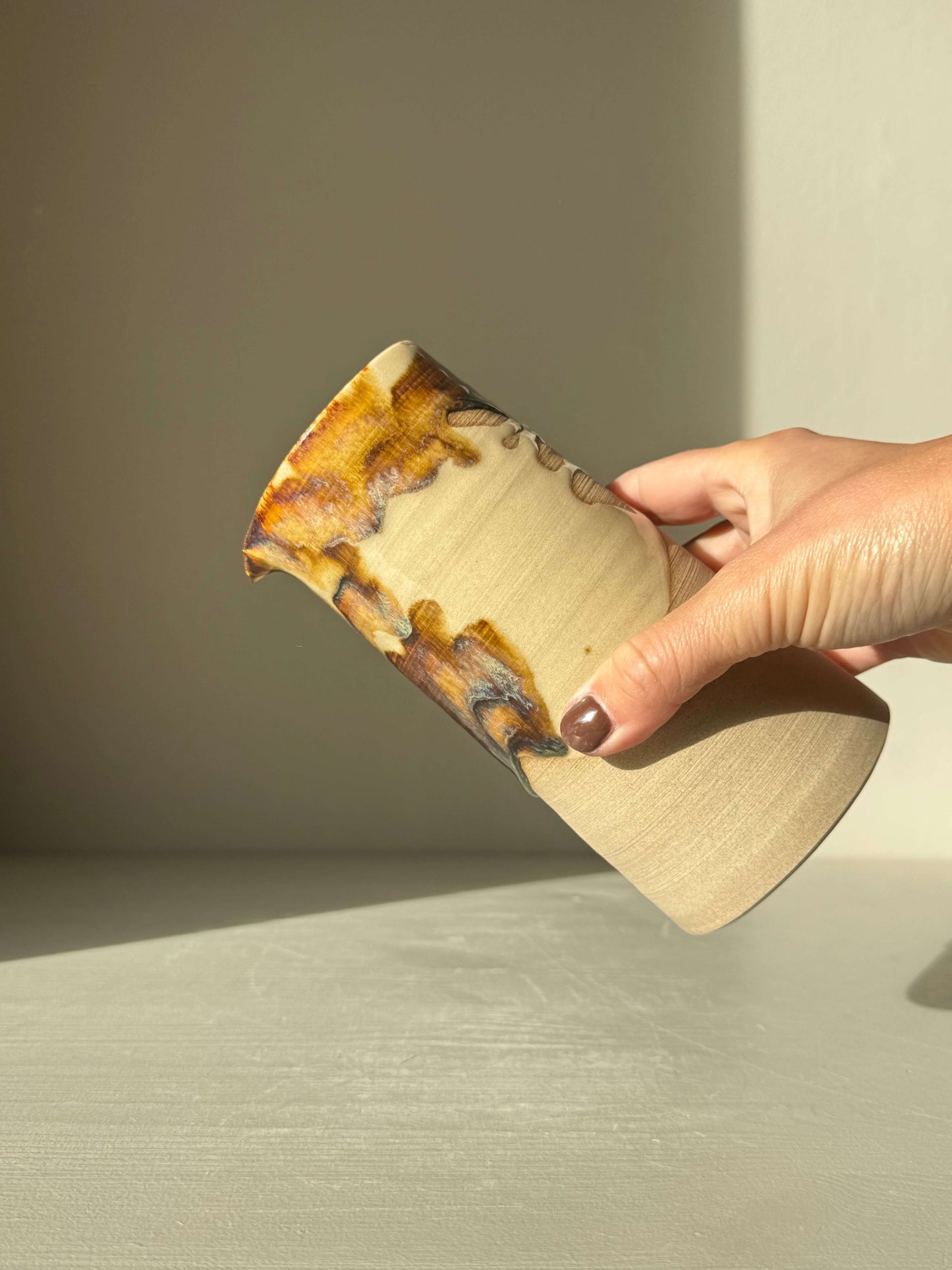 Hand holding Medium Vase/Jug – Inyo Series #01 showcasing natural glaze and raw texture; multipurpose artistry for home or studio use.