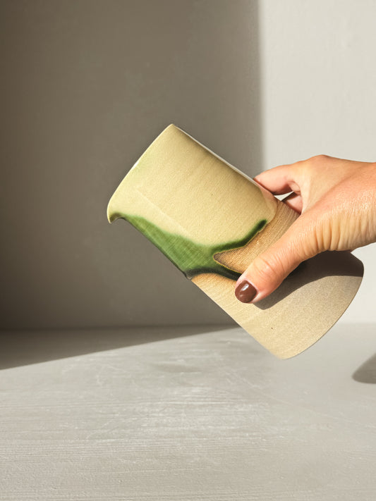 Hand holding Medium Vase/Jug – Mori #02 in natural light showcasing glossy green glaze and toffee clay base.