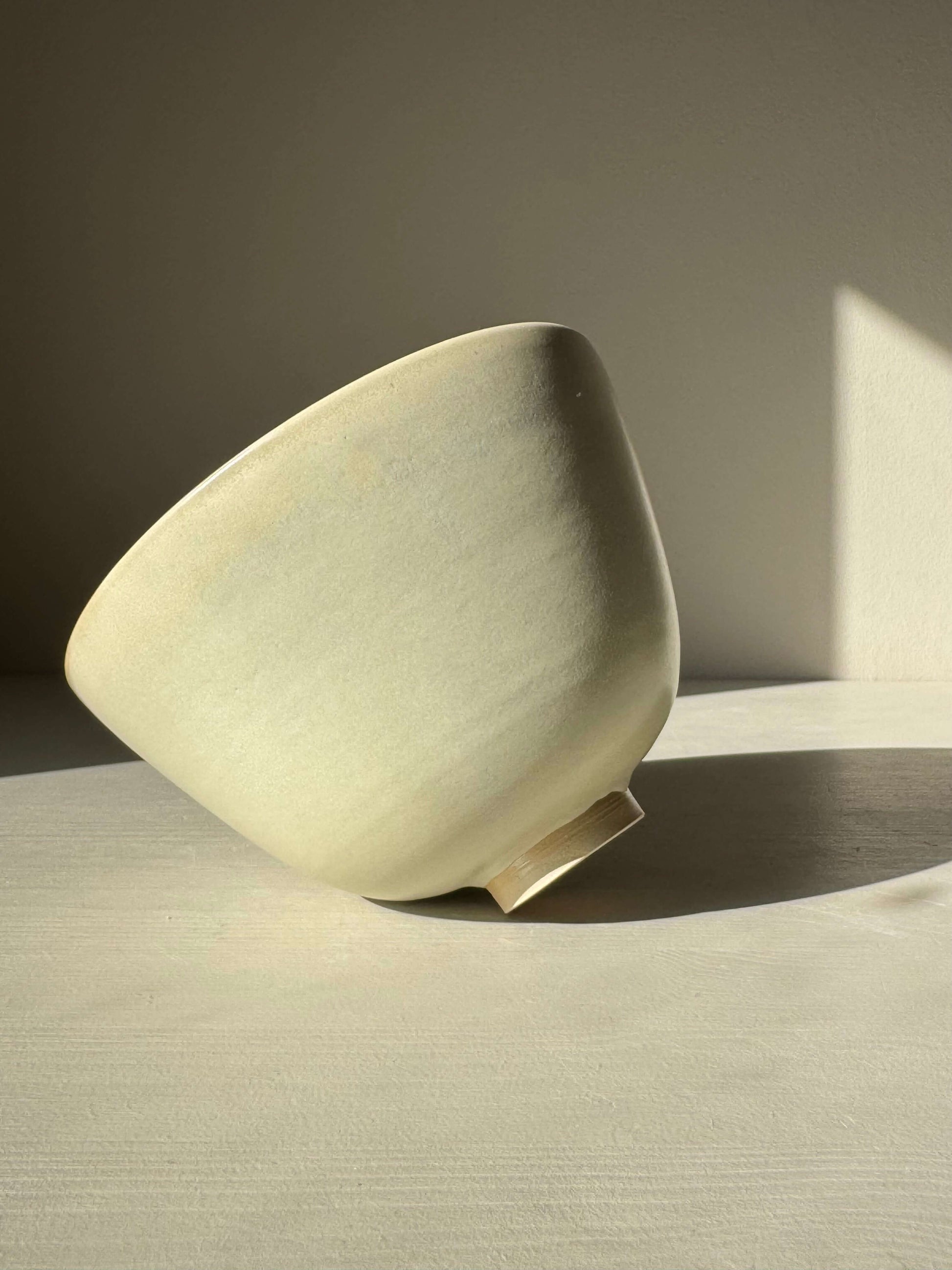 Handmade ceramic Bowl - Moonstone #01 with moonstone glaze, tall rounded shape, and raised foot, showcasing quiet beauty and durability.