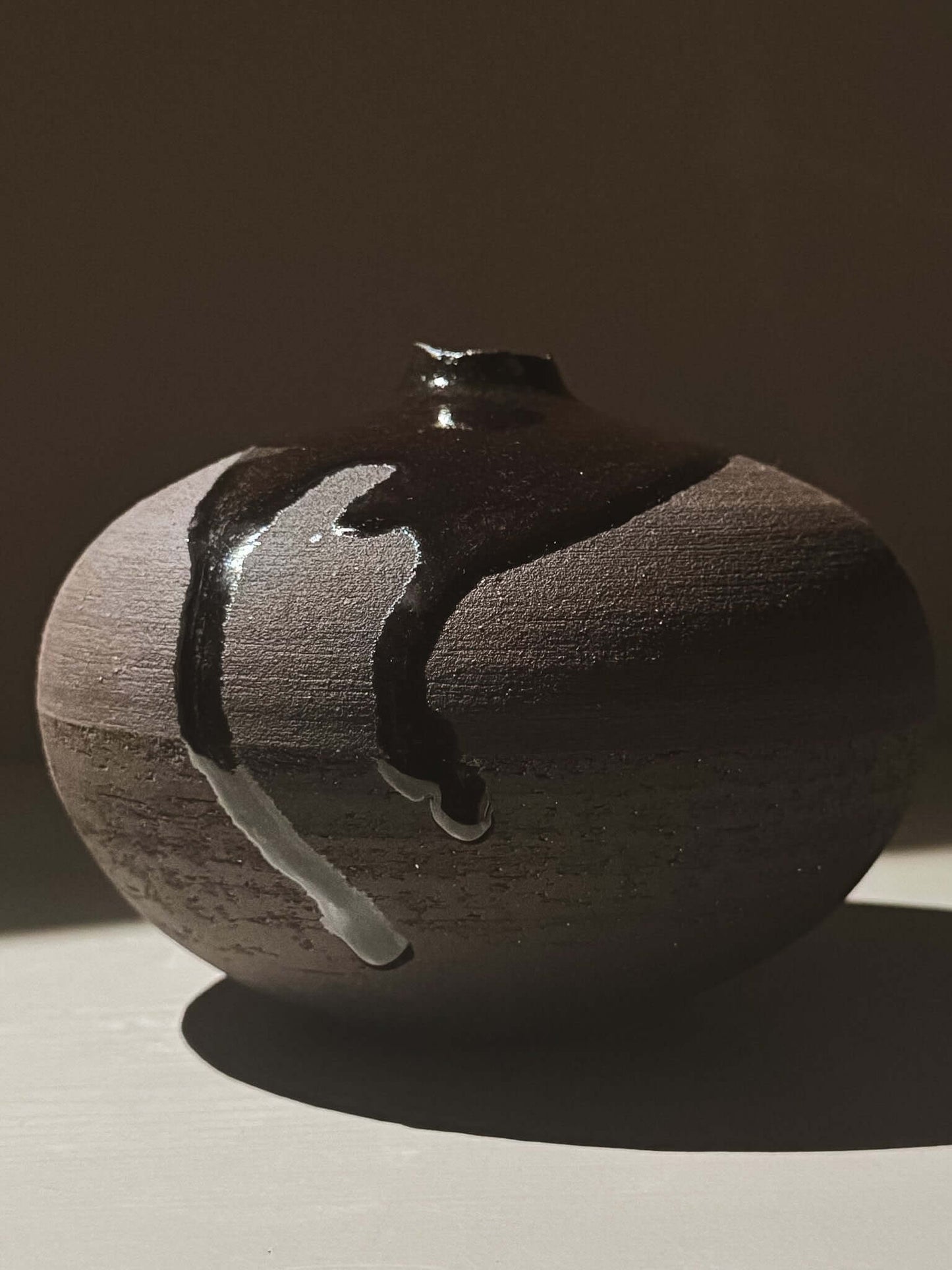 Orb Vase – Kuro Black #01 with unique glaze patterns and spherical design, part of a handcrafted round vessel collection for home decor.