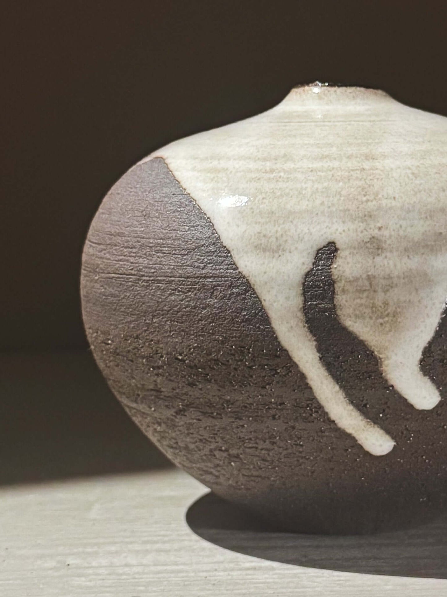Orb Vase – Yuki Black #04 showcasing a unique glaze pattern and soft spherical shape.