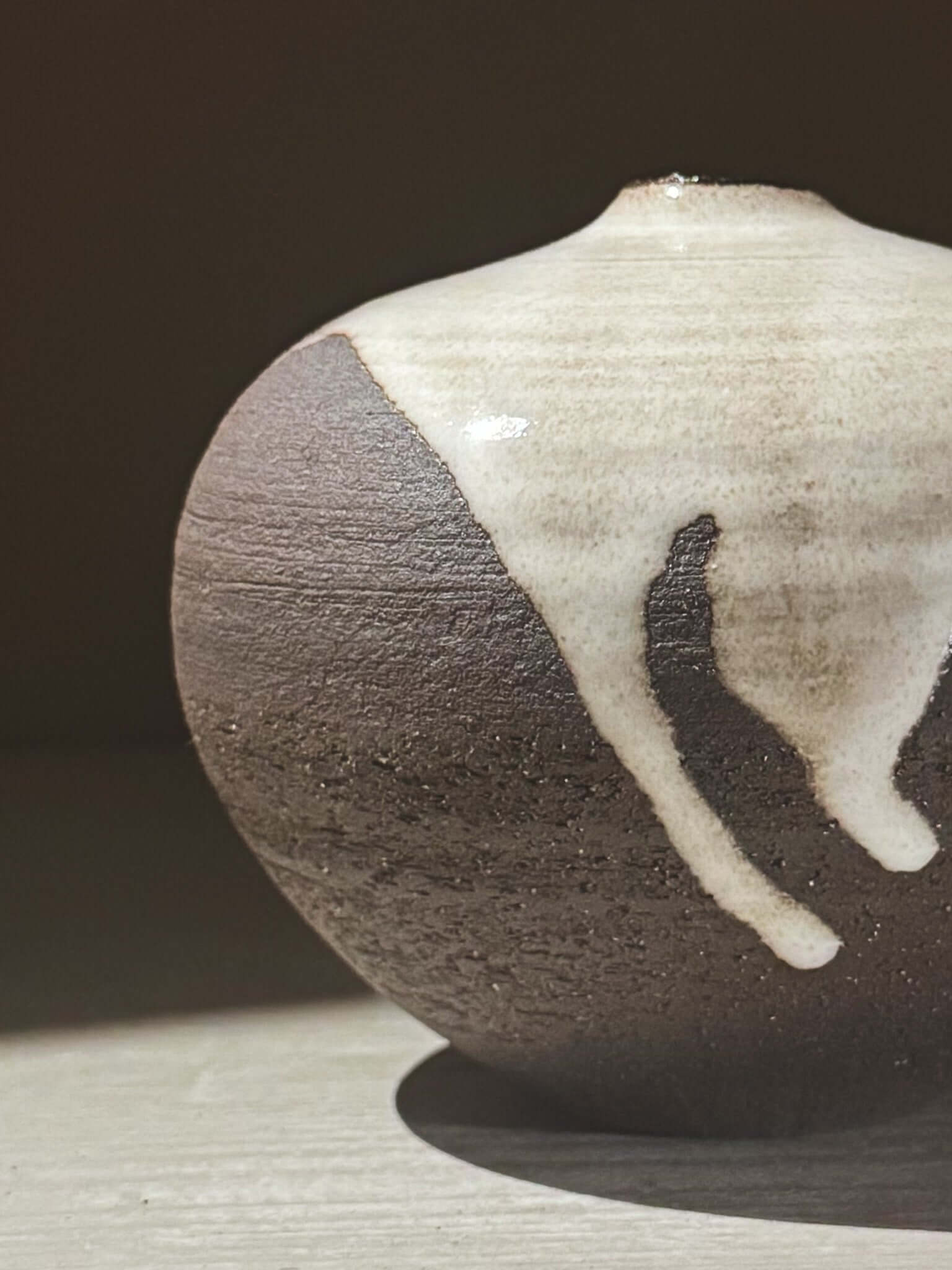 Orb Vase – Yuki Black #04 showcasing a unique glaze pattern and soft spherical shape.