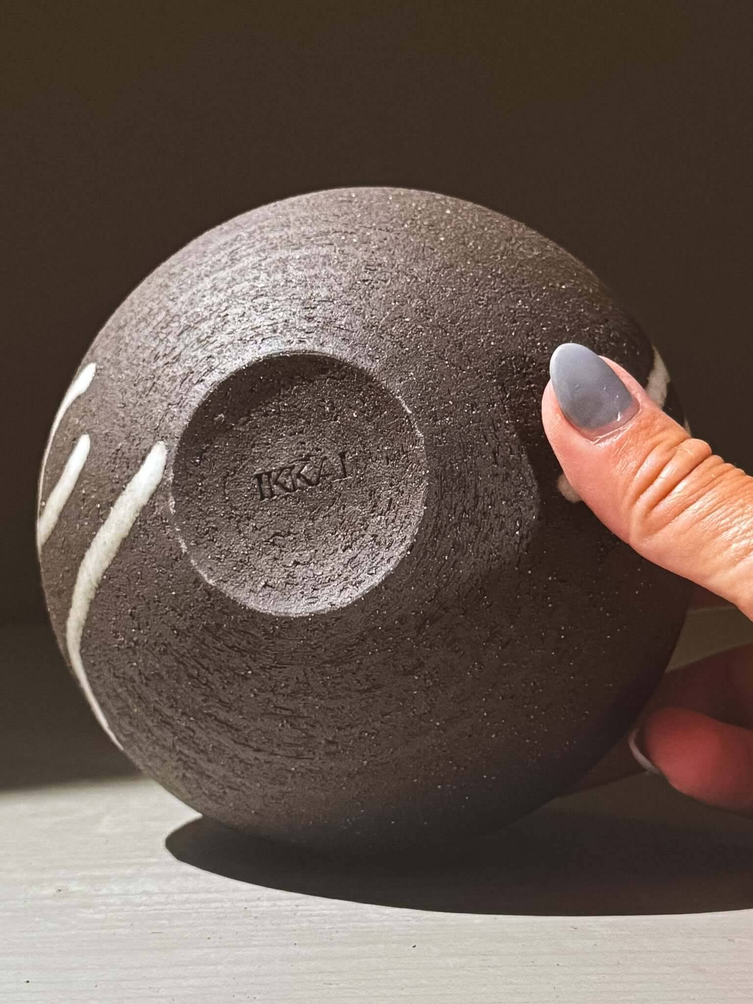 Orb Vase – Yuki Black #05 displayed from below, showcasing unique glaze movement and textured finish.