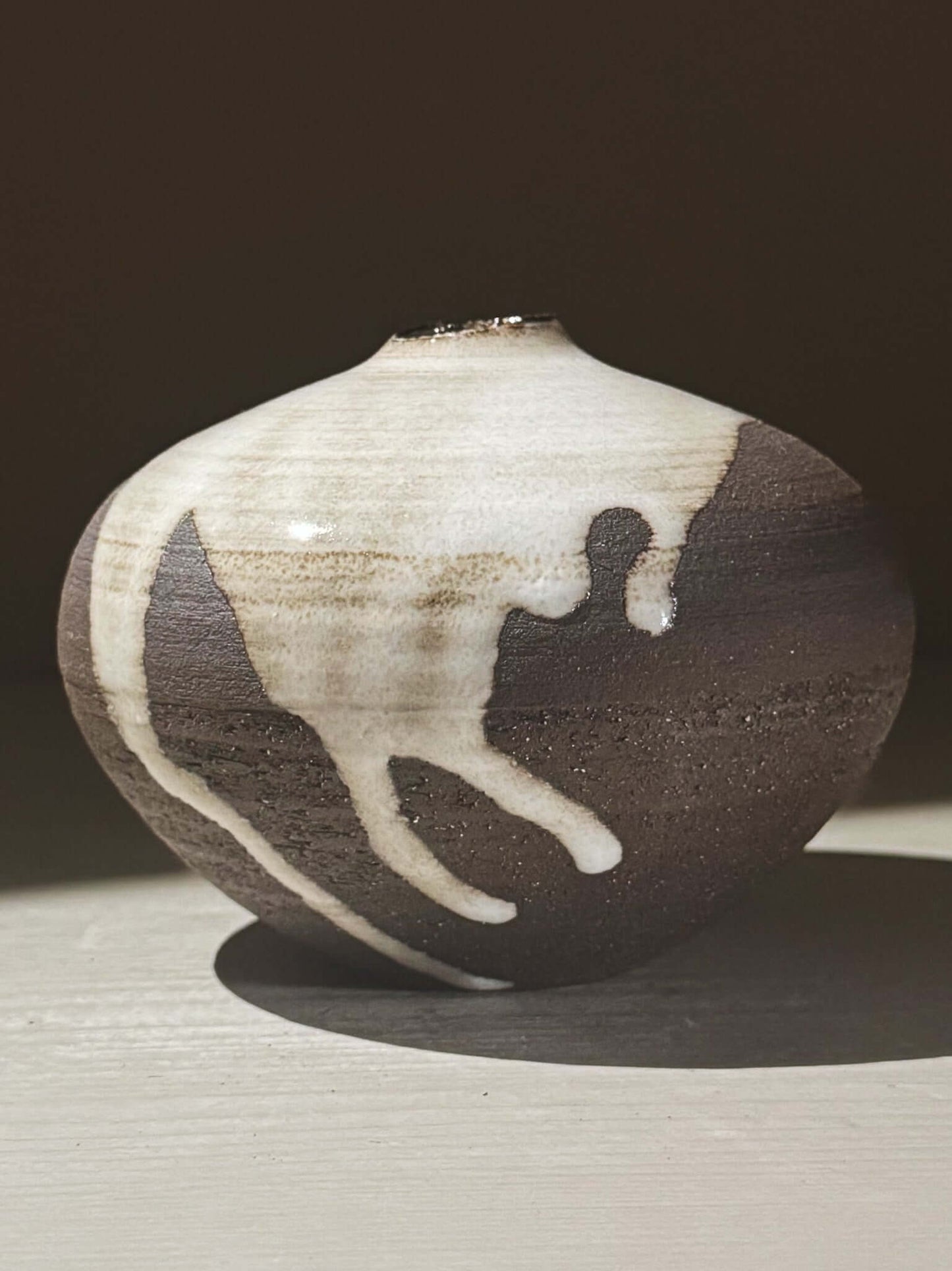 Orb Vase – Yuki Black #05 showcasing unique glaze movement and a soft spherical form.
