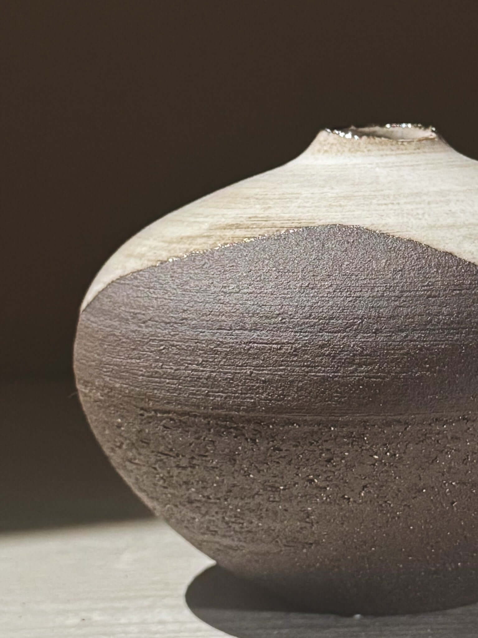 Orb Vase – Yuki Black #05 showcasing unique glaze movement and sculptural rounded form on a soft lit surface.
