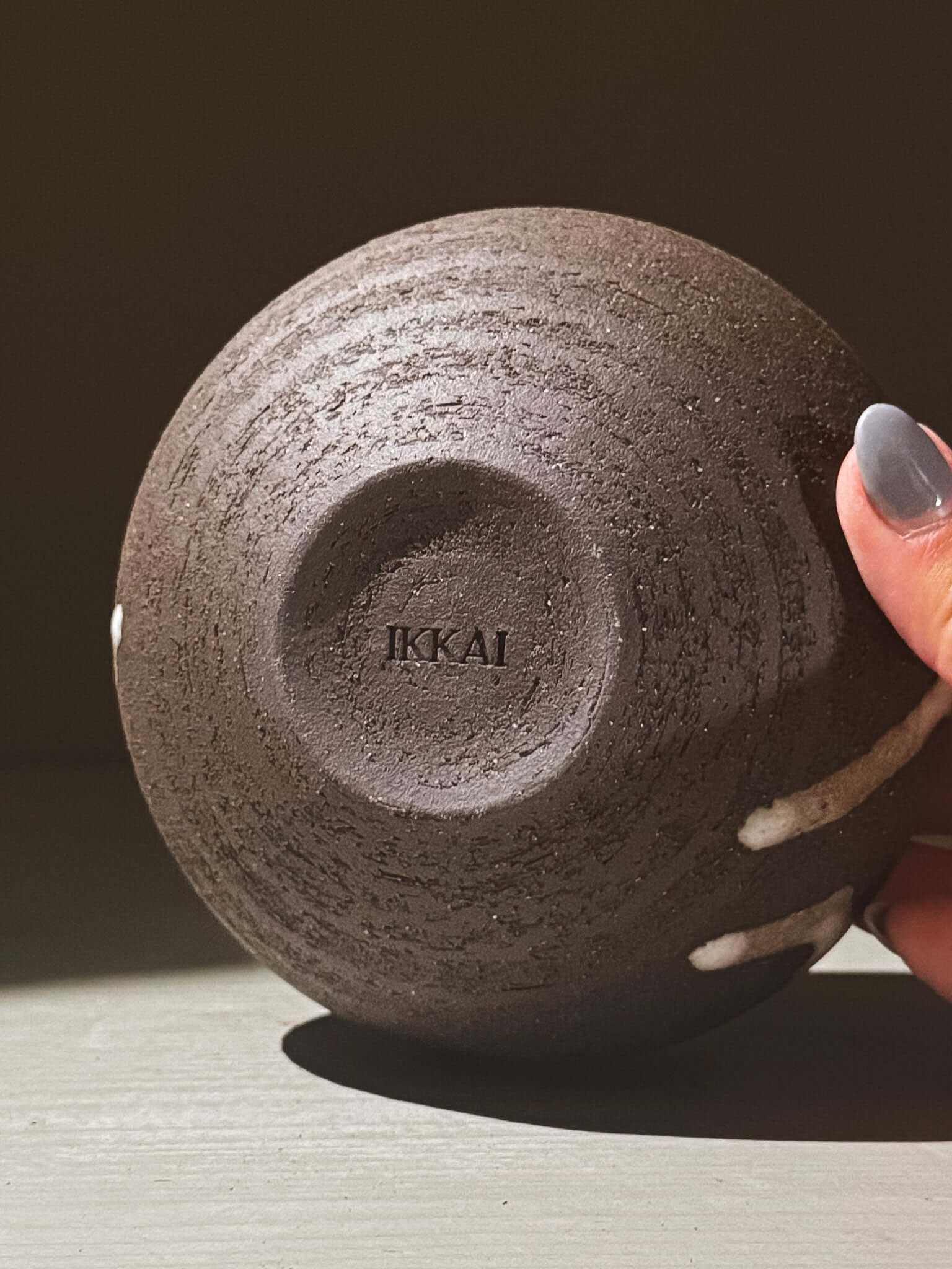 Orb Vase – Yuki Black #06 with a textured surface and unique glaze patterns, showcasing its sculptural presence.