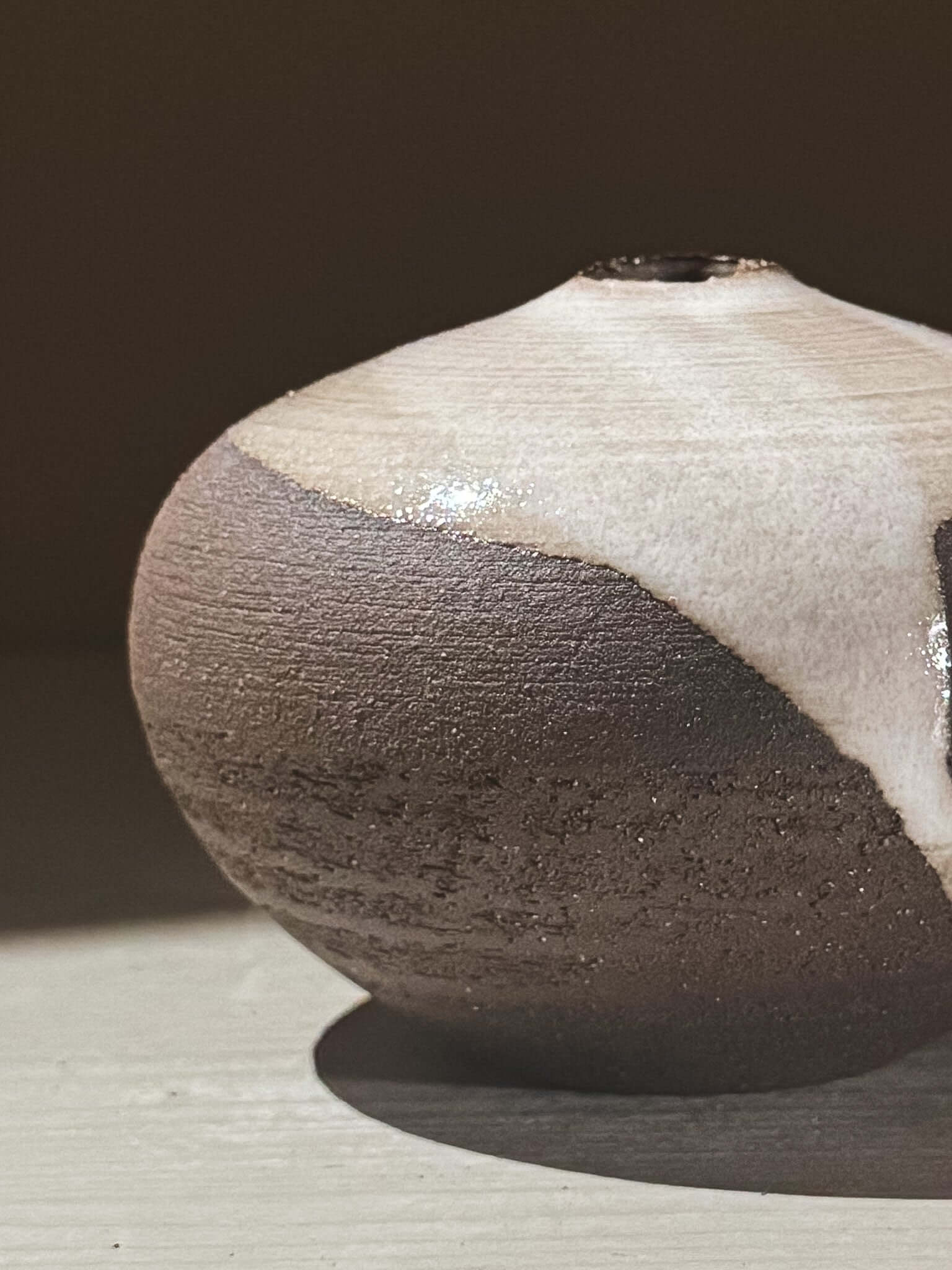 Orb Vase – Yuki Black #06 with unique glaze patterns and soft rounded shape, showcasing organic textures.