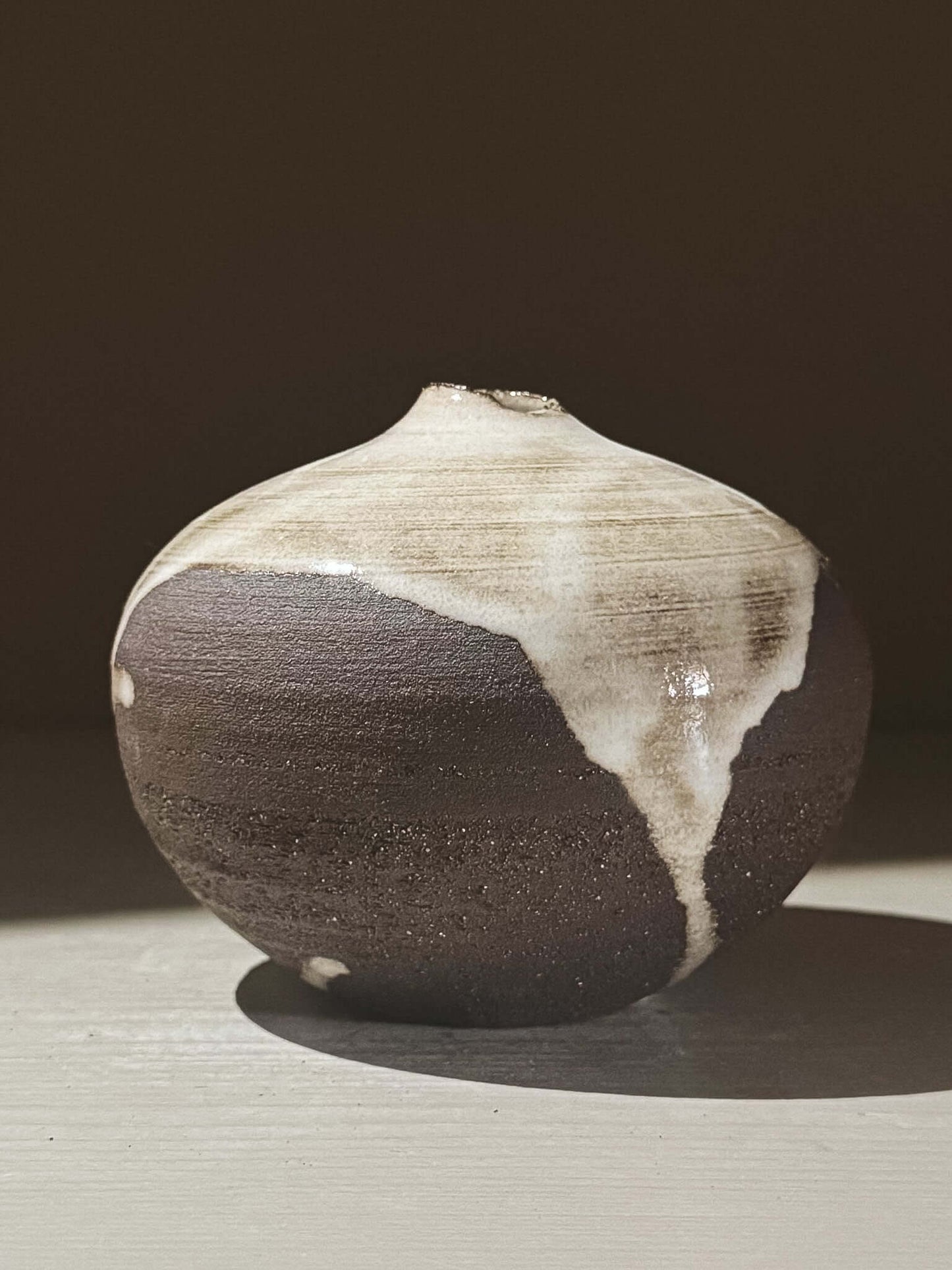 Orb Vase – Yuki Black #07 with unique glaze pattern and soft spherical shape, showcasing organic artistic design.