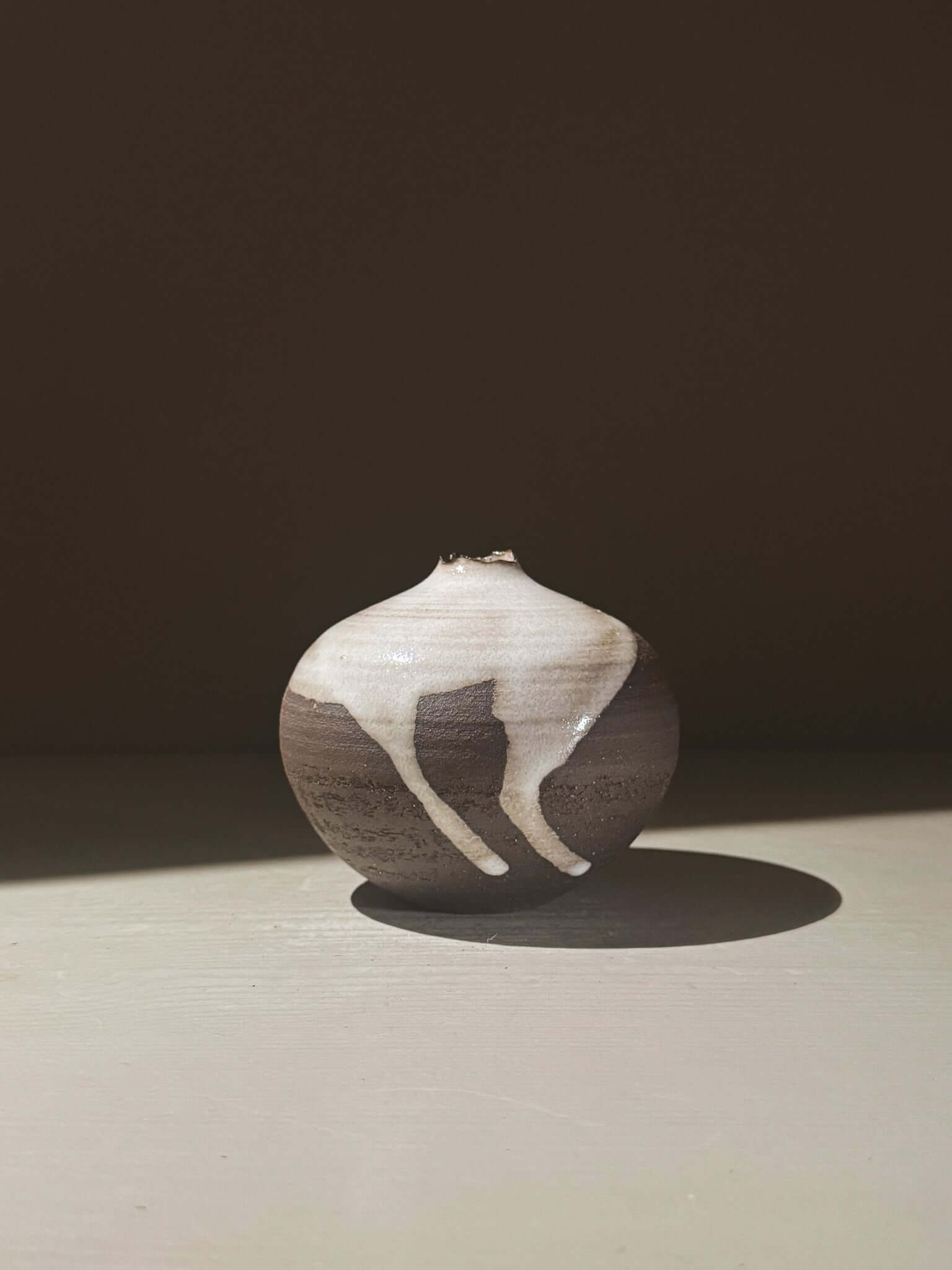 Orb Vase – Yuki Black #08 showcasing unique glaze patterns and soft spherical form.