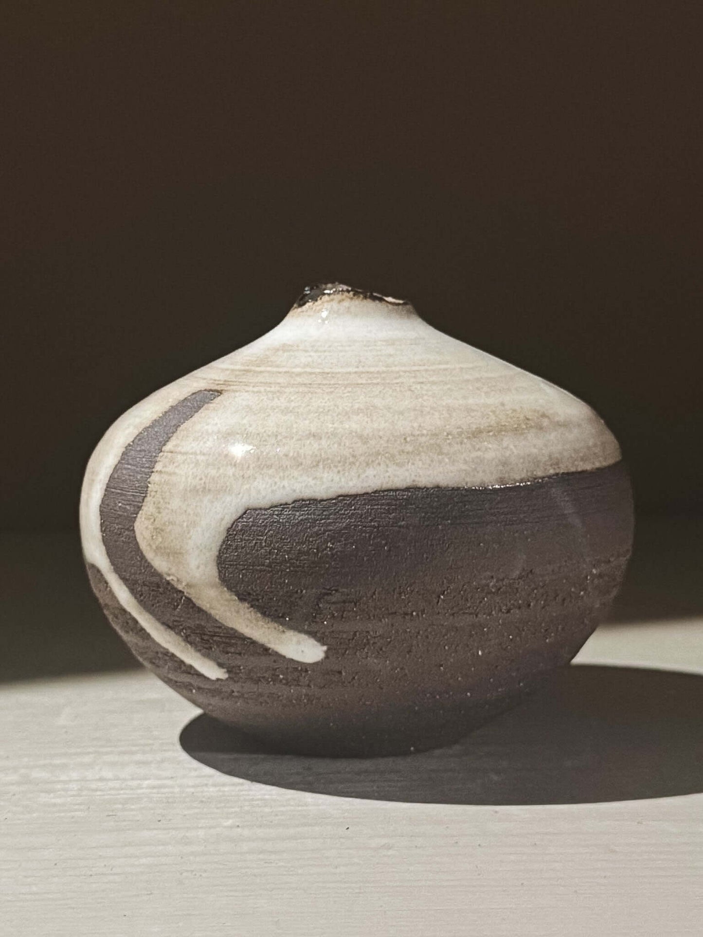 Orb Vase – Yuki Black #09 with unique glaze patterns and soft spherical form, showcasing its artistic design.
