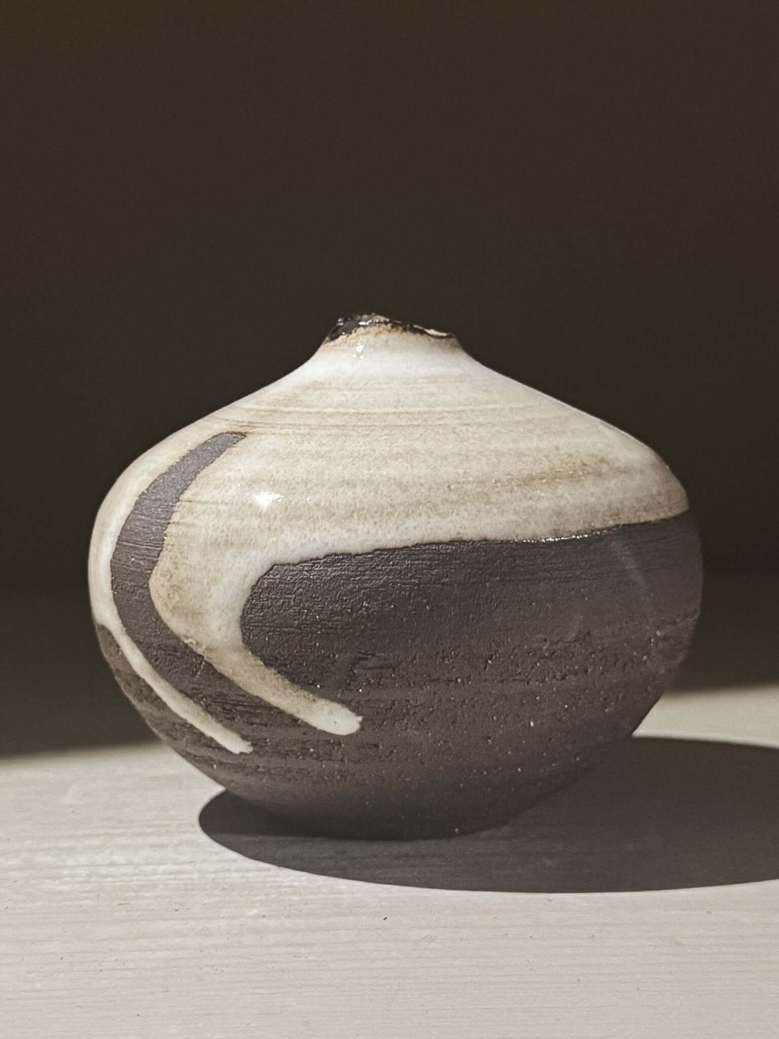 Orb Vase – Yuki Black #09 with unique glaze patterns and soft spherical form, showcasing its artistic design.