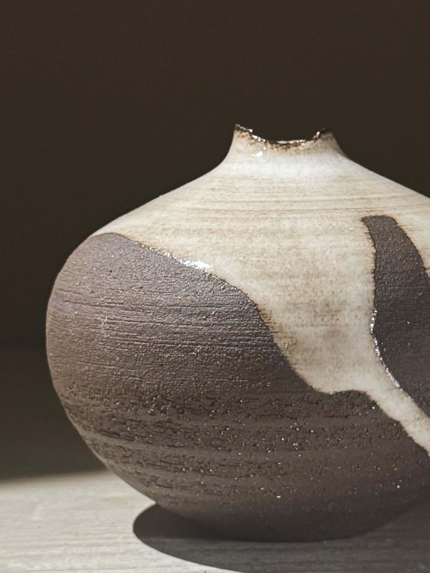 Orb Vase – Yuki Black #09 showcasing unique glaze patterns and soft spherical form in natural light.
