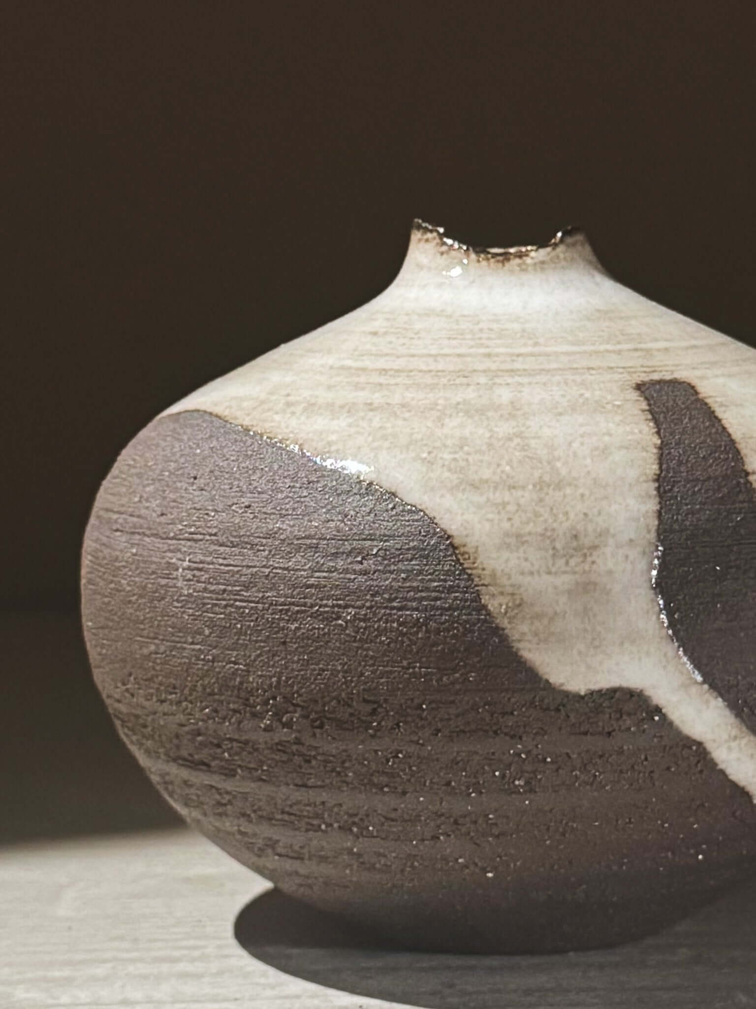 Orb Vase – Yuki Black #09 showcasing unique glaze patterns and soft spherical form in natural light.