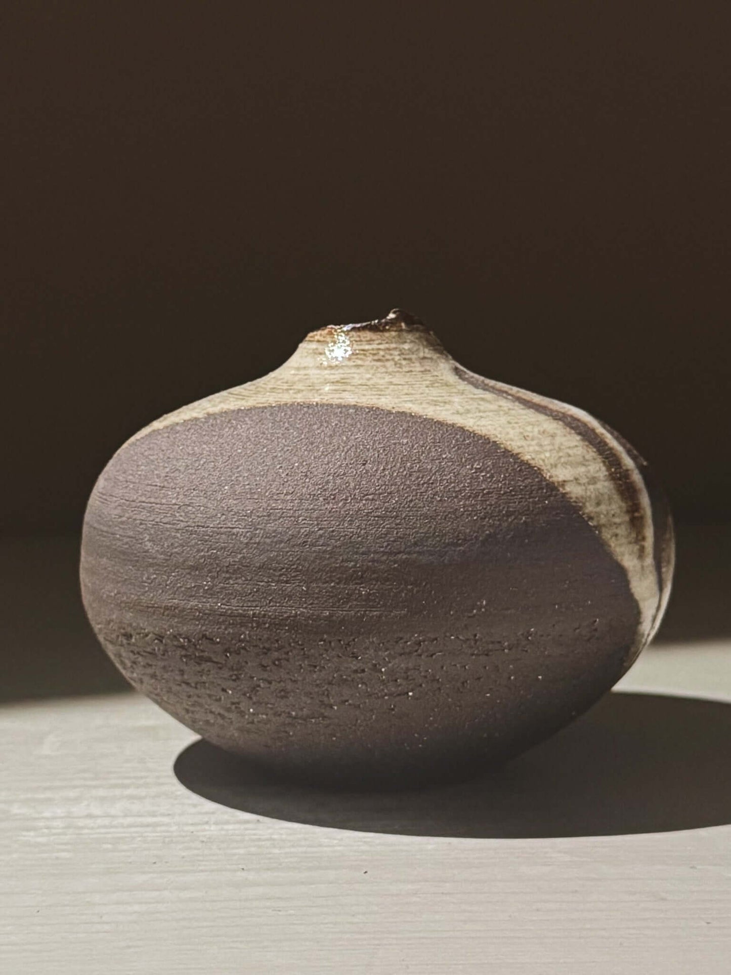 Orb Vase – Yuki Black #10 showcasing a unique rounded design and organic glaze patterns.