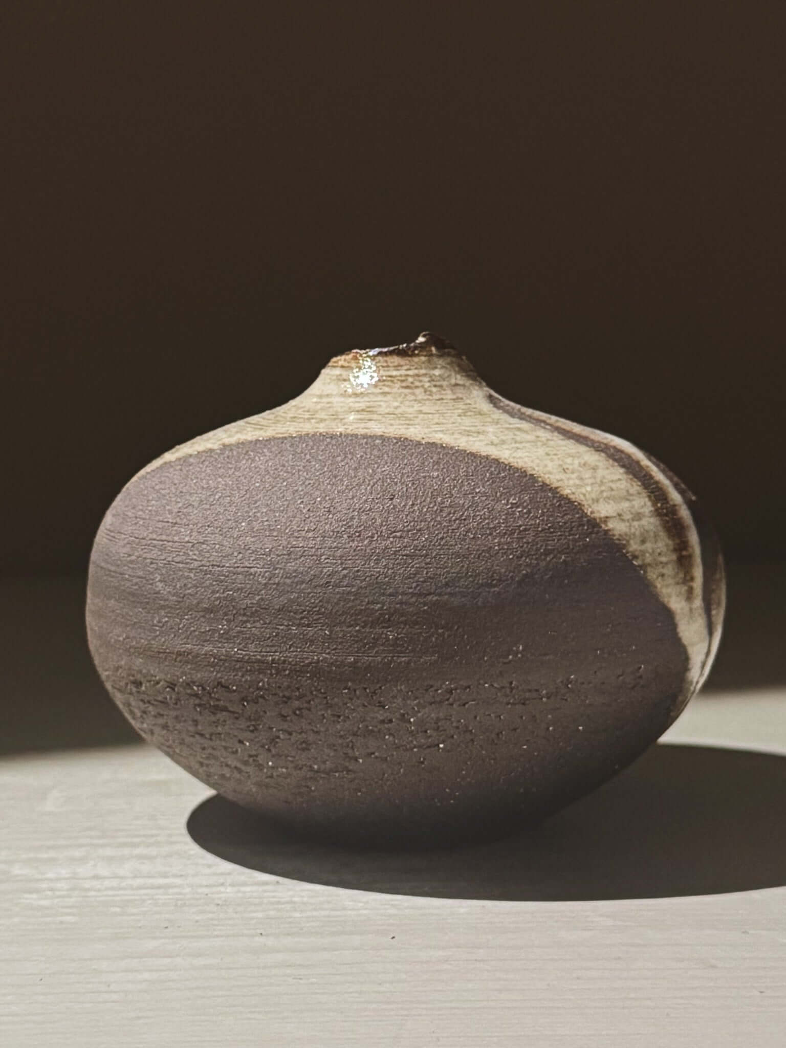 Orb Vase – Yuki Black #10 showcasing a unique rounded design and organic glaze patterns.