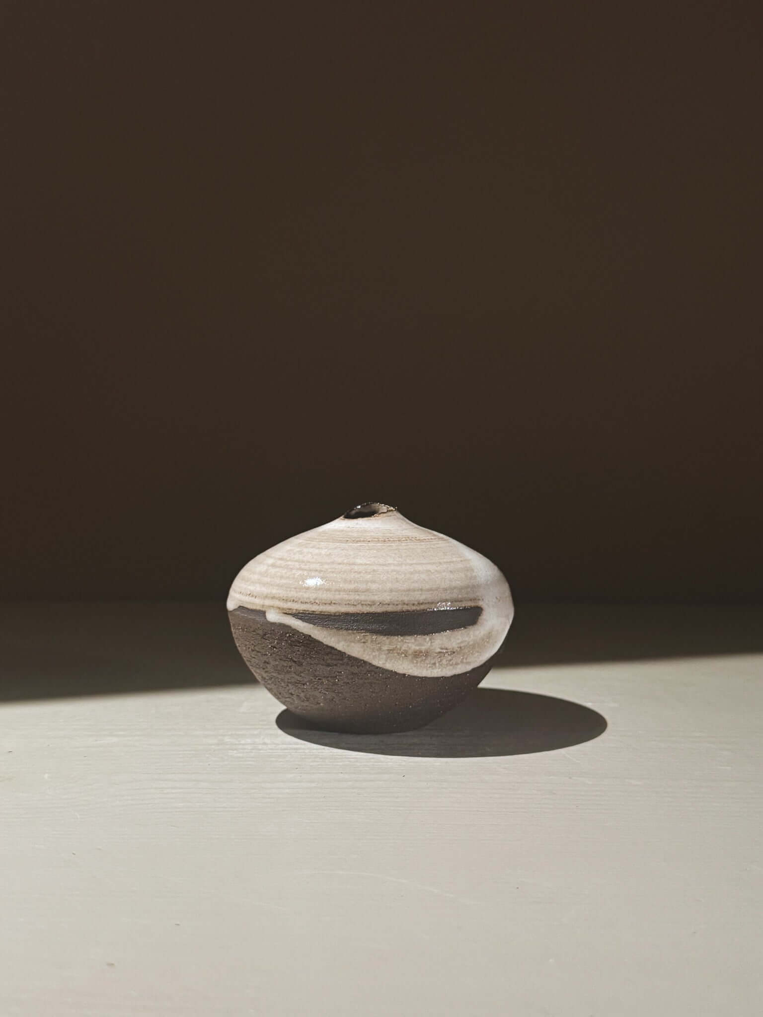 Orb Vase – Yuki Black #11 with organic glaze patterns and a sculptural spherical design.