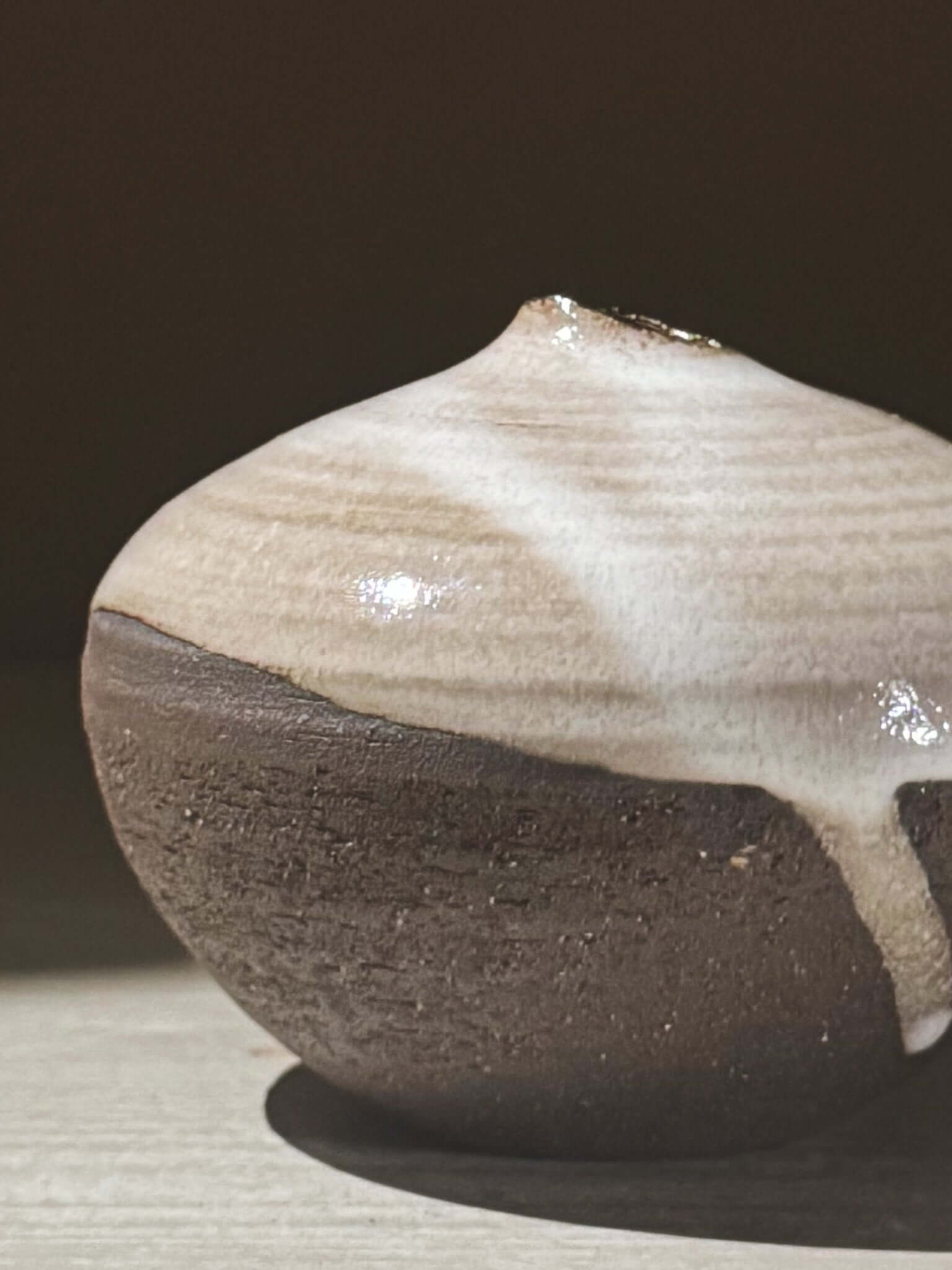 Orb Vase – Yuki Black #11 with unique glaze and sculptural form, displaying gentle drips and organic patterns on the rounded vessel.