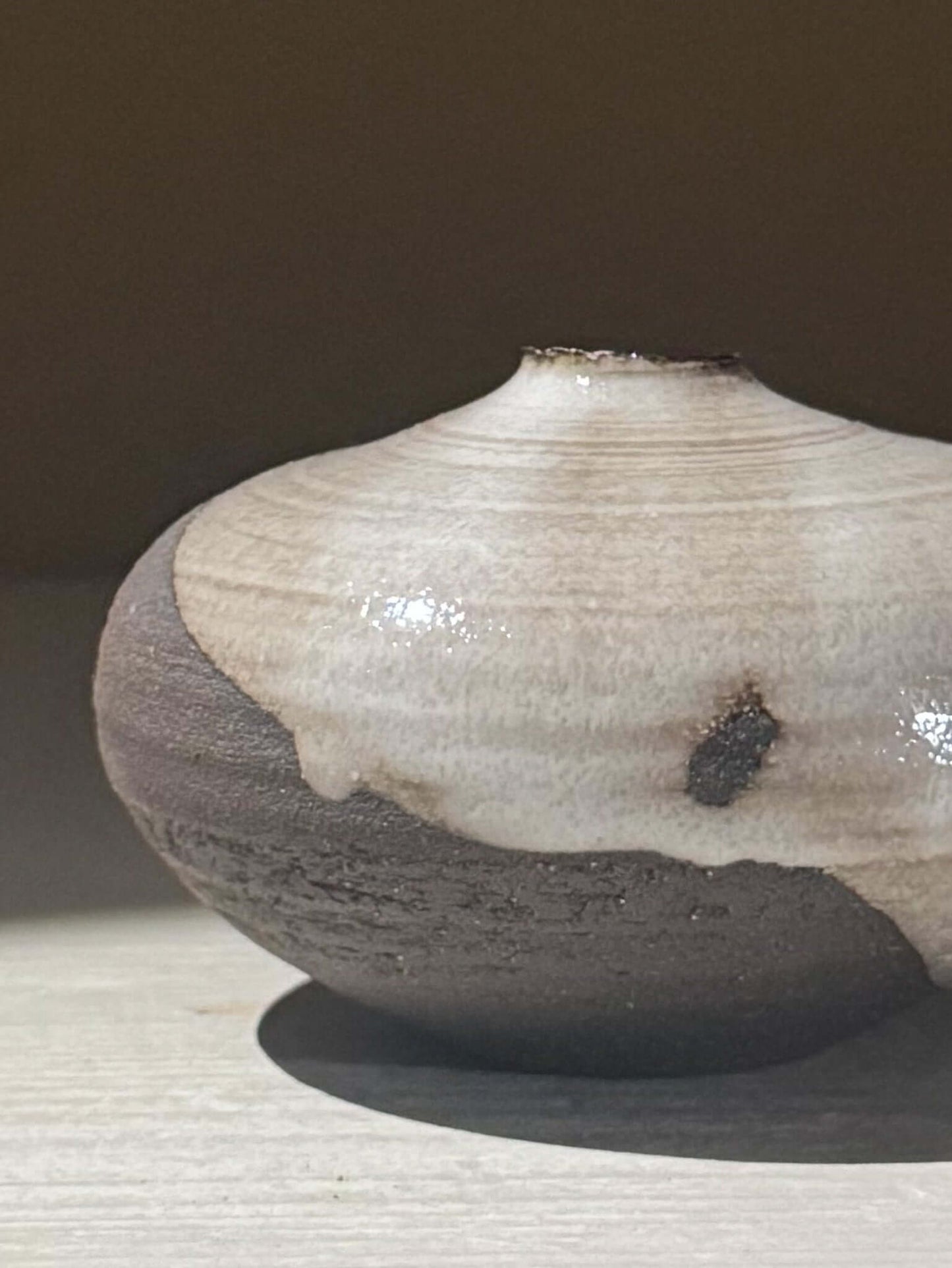 Orb Vase – Yuki Black #13 displaying unique glaze patterns on a softly rounded form.