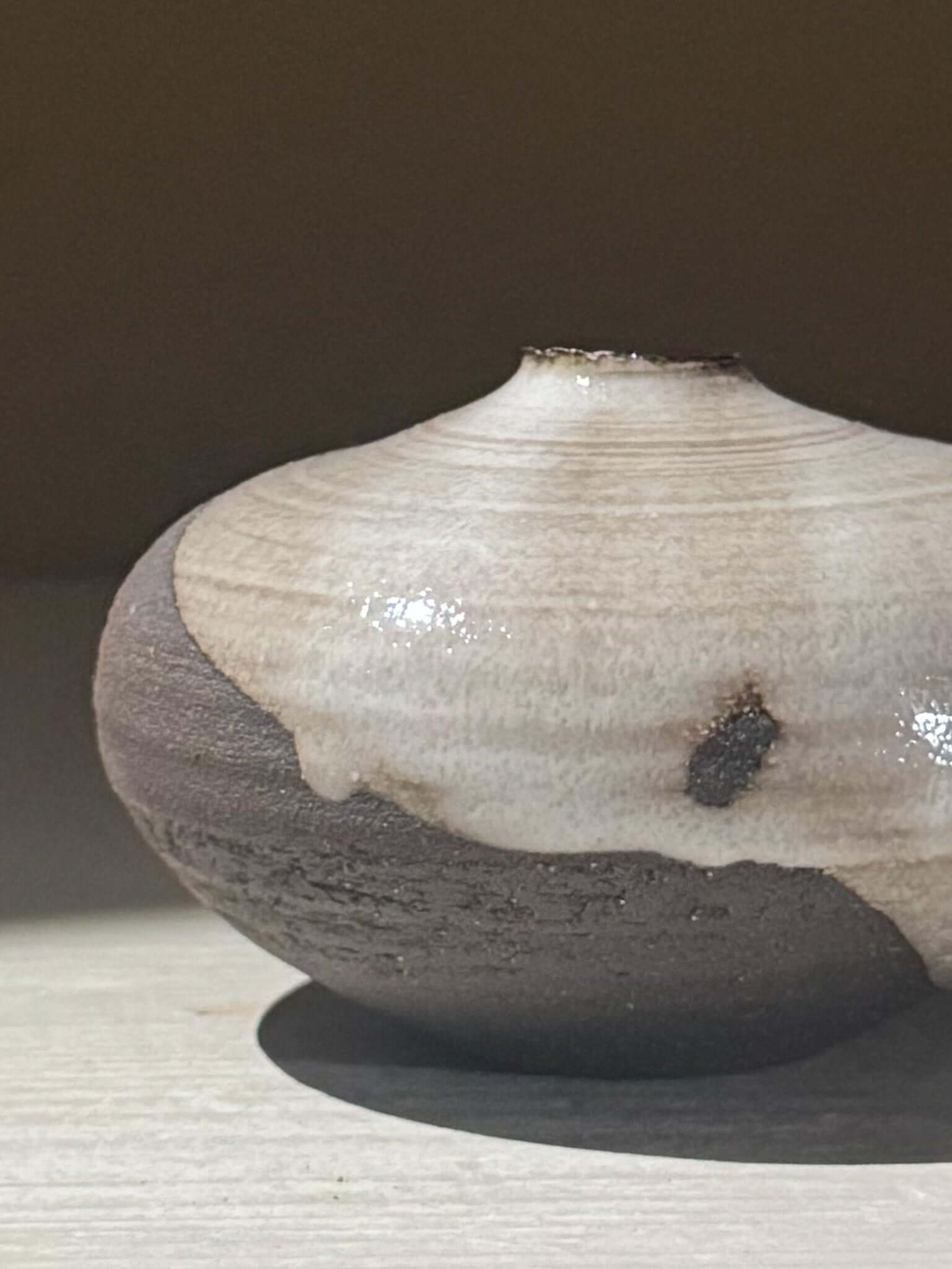 Orb Vase – Yuki Black #13 displaying unique glaze patterns on a softly rounded form.