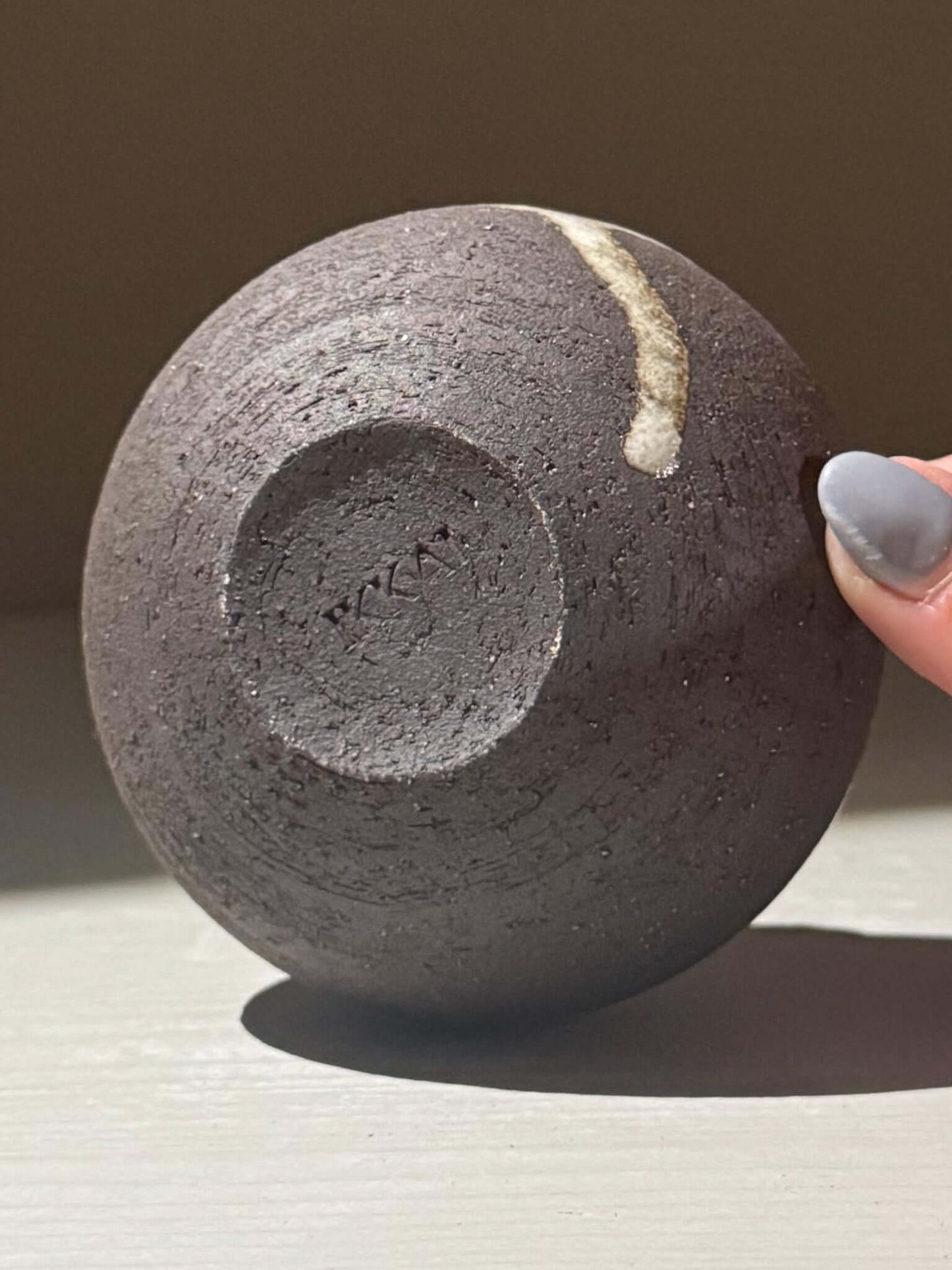 Orb Vase – Yuki Black #14 with unique glaze drips and textured clay base displayed on a surface