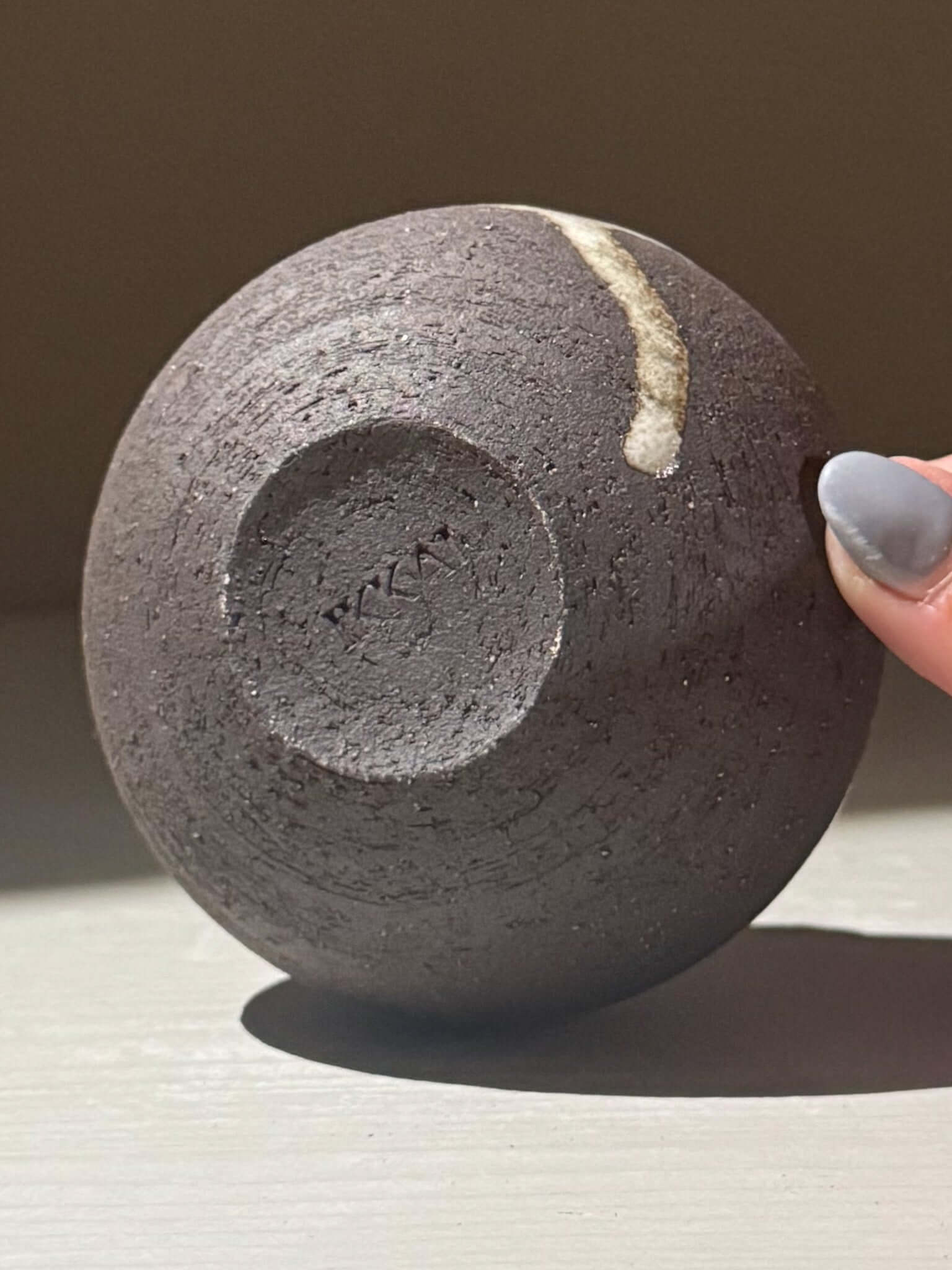 Orb Vase – Yuki Black #14 with unique glaze drips and textured clay base displayed on a surface
