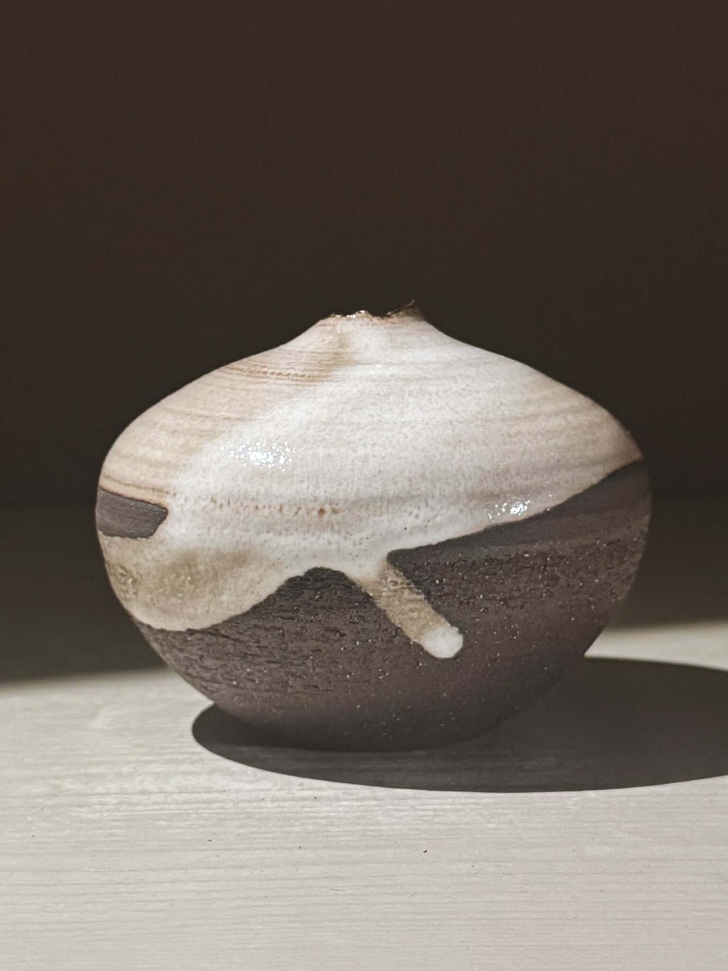 Orb Vase – Yuki Black #11 with unique glaze and rounded design on display