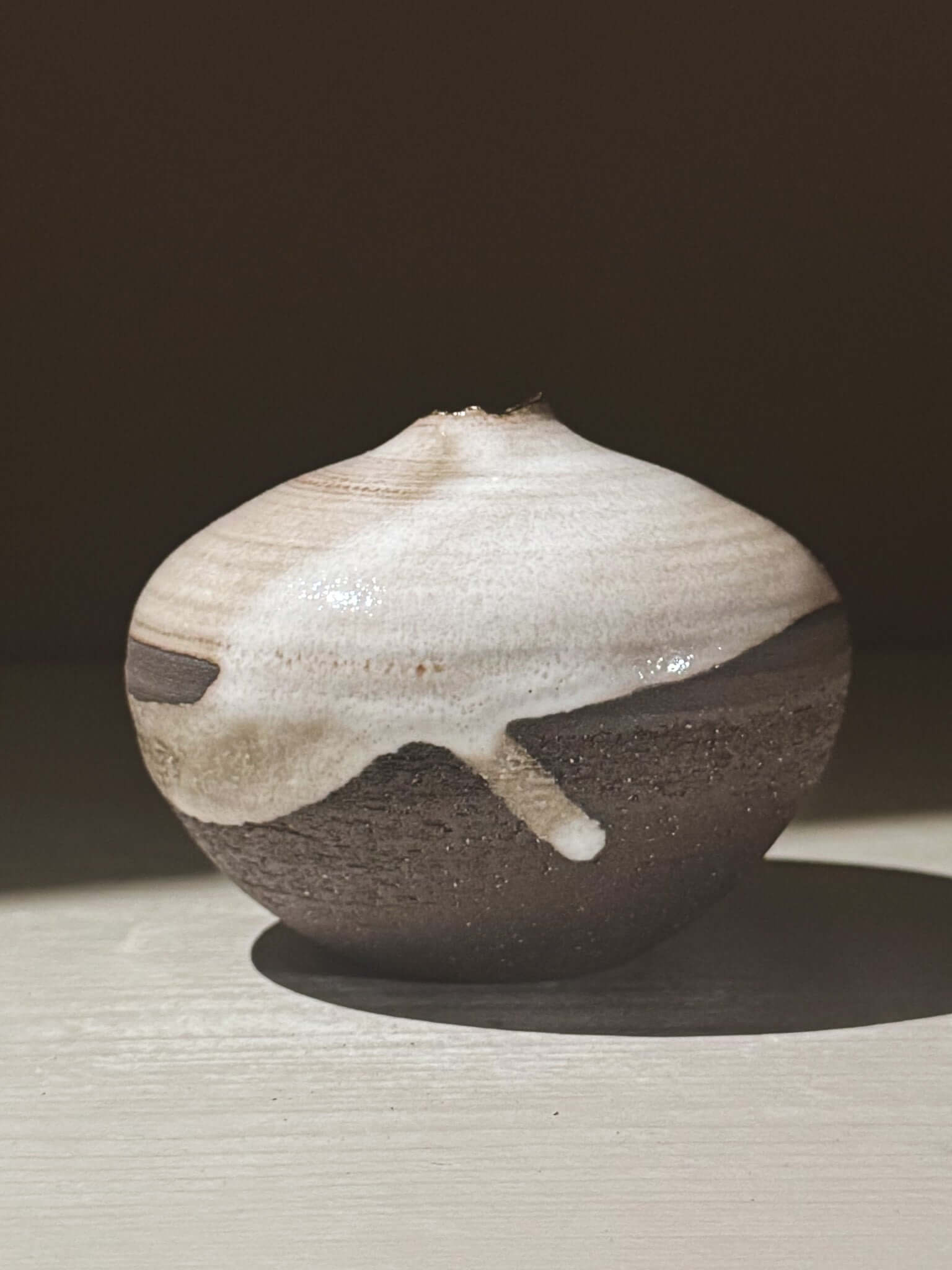 Orb Vase – Yuki Black #11 with unique glaze and rounded design on display