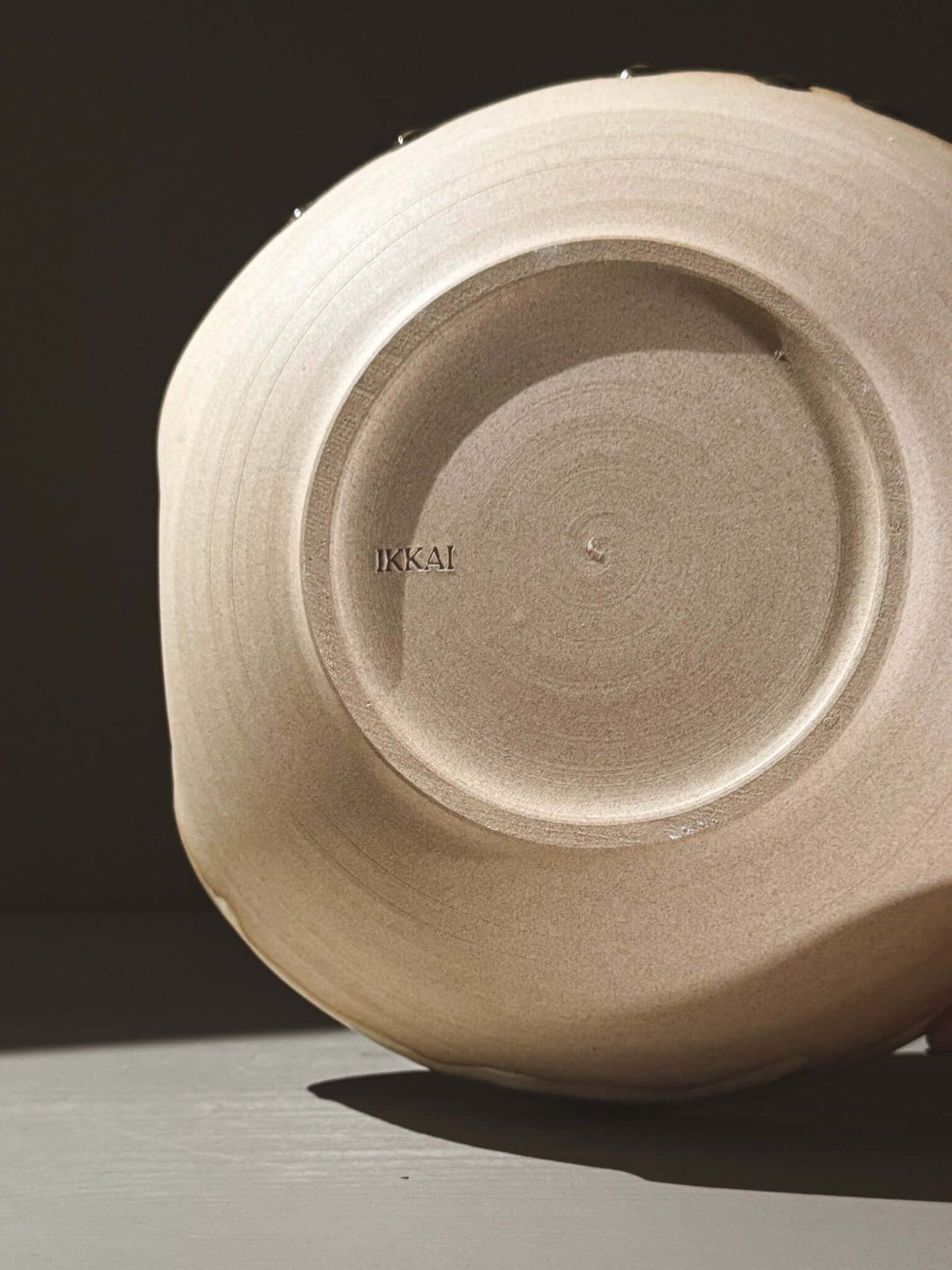 Handmade bottom view of a Salad/Pasta Plate – Inyo showcasing unique glaze and craftsmanship.