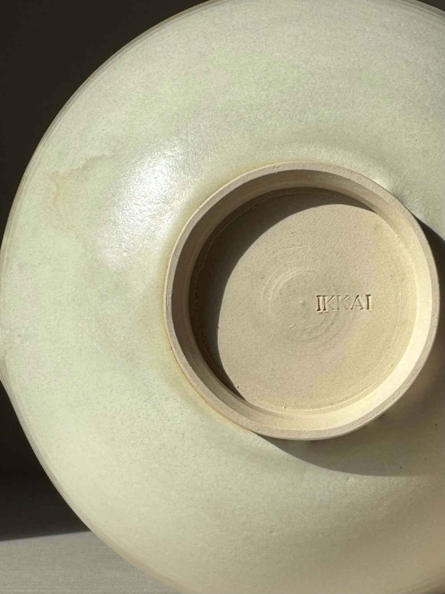 Base of a handmade ceramic Pouring Bowl – Moonstone, showing delicate layering and Moonstone glaze finish.