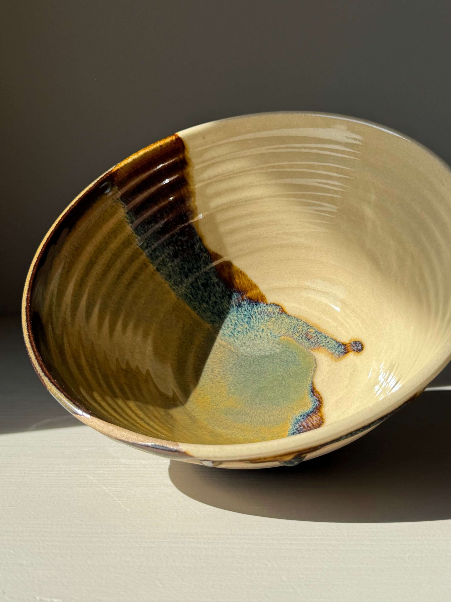Handmade ceramic Ramen Bowl - Inyo with glossy tenmoku and clear glaze design highlighting toffee clay.