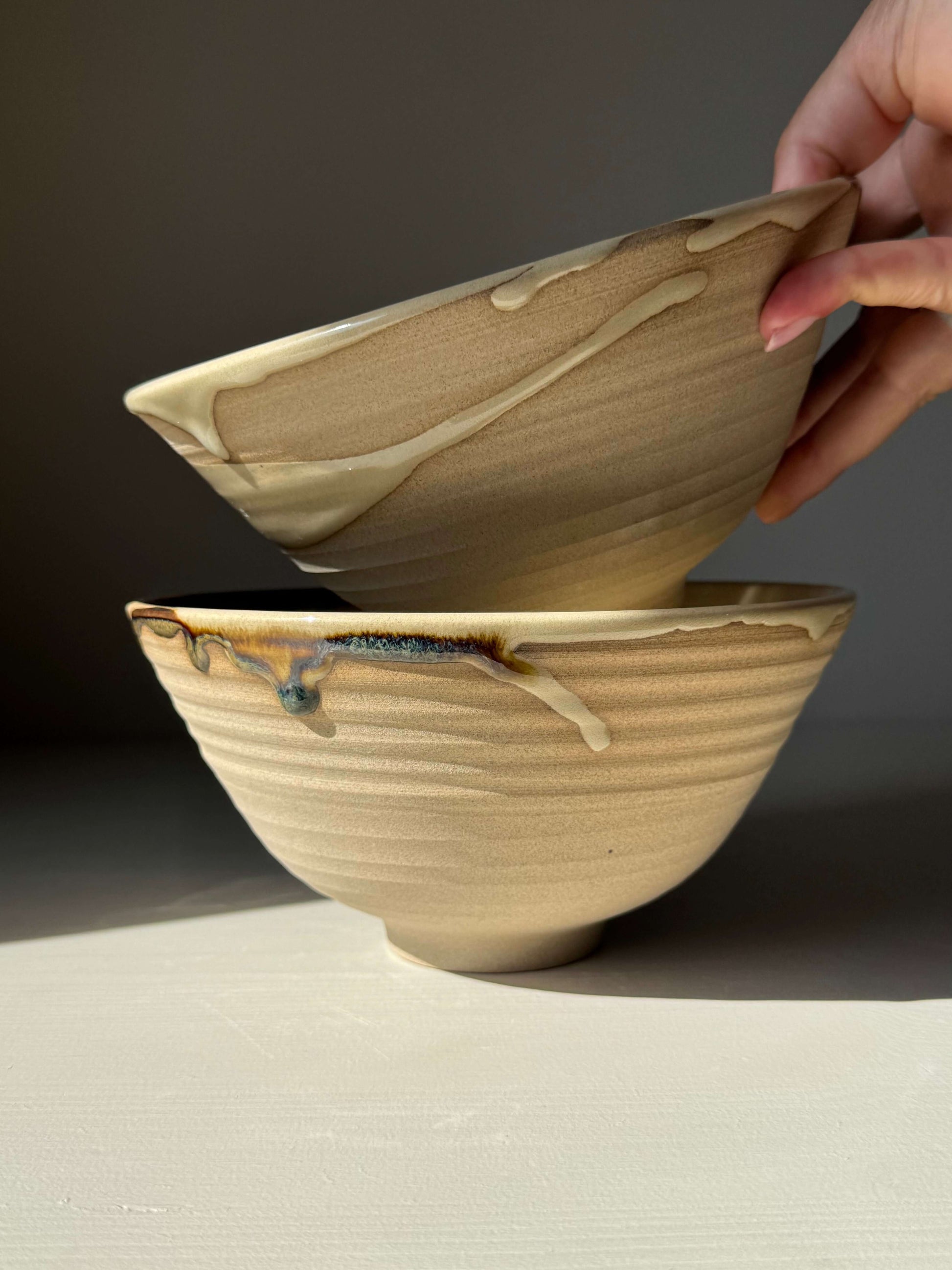 Handmade ceramic Ramen Bowl - Inyo with glossy tenmoku glaze and toffee clay finish, showcasing a unique artistic design.