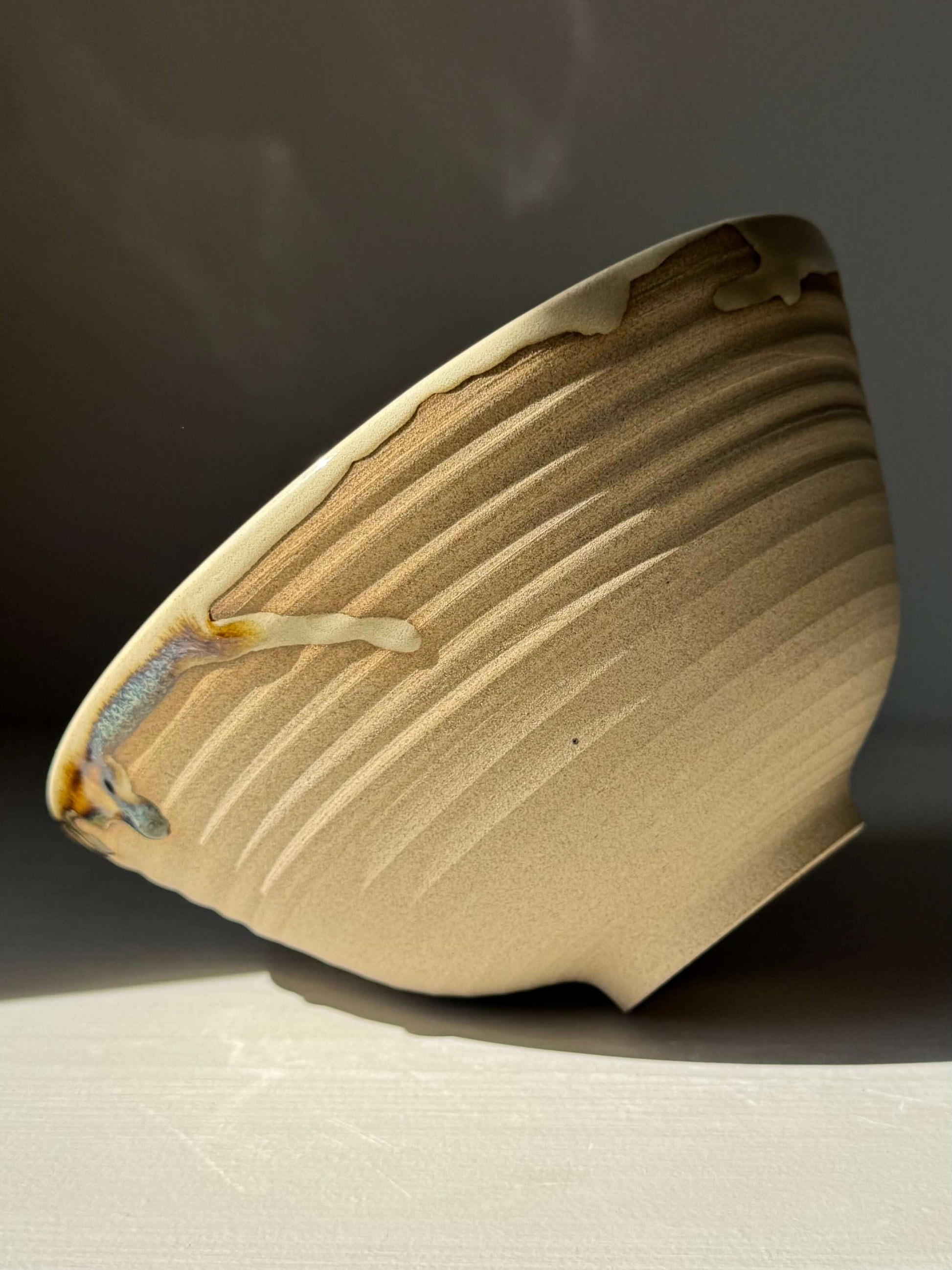 Handmade ceramic Ramen Bowl - Inyo Series with glossy tenmoku and clear glaze, showcasing toffee clay color.