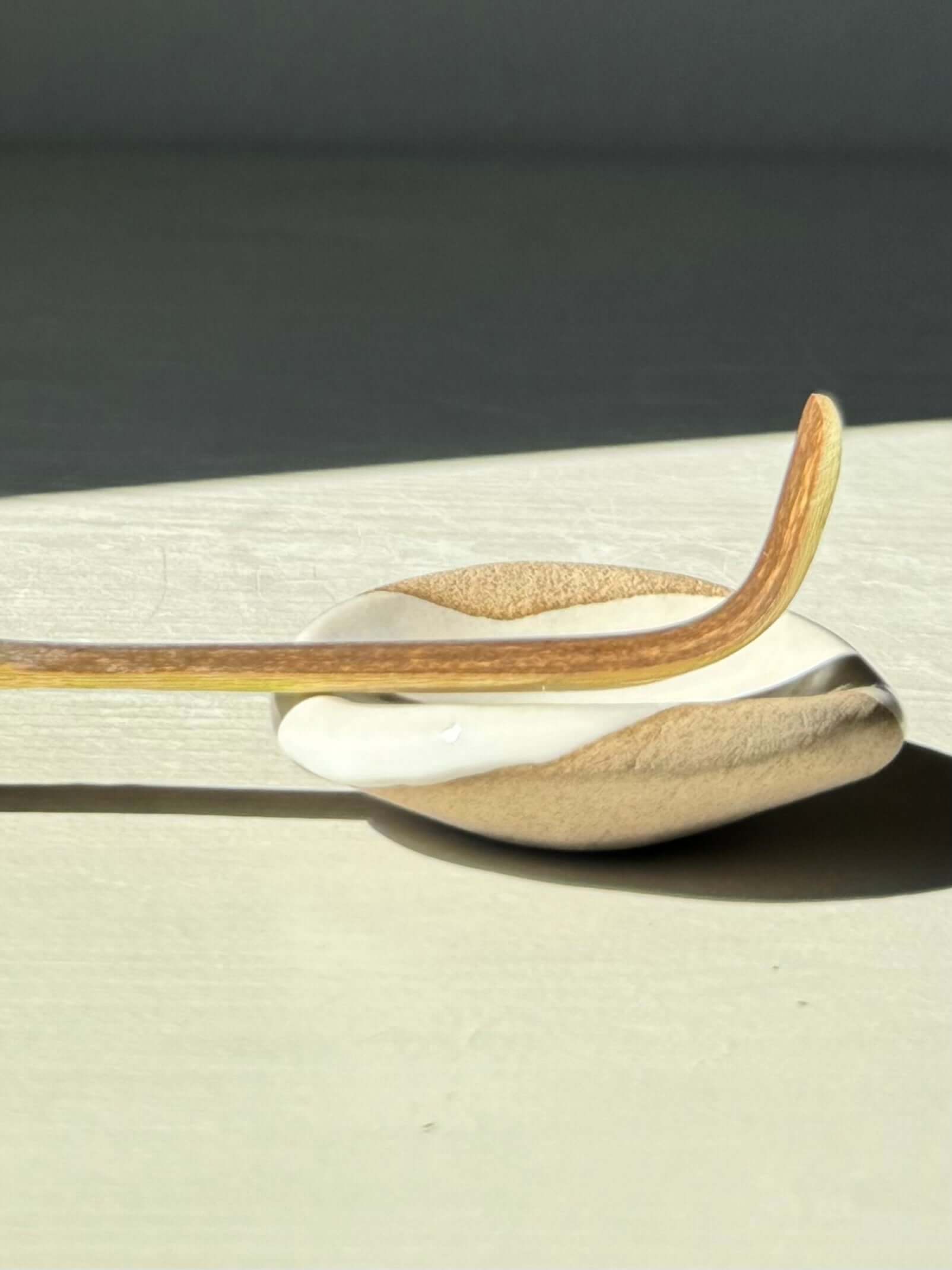 Round Chopstick/Spoon Rest – Yuki, handmade ceramic holder with organic curves, white glaze, and raw clay in natural contrast.