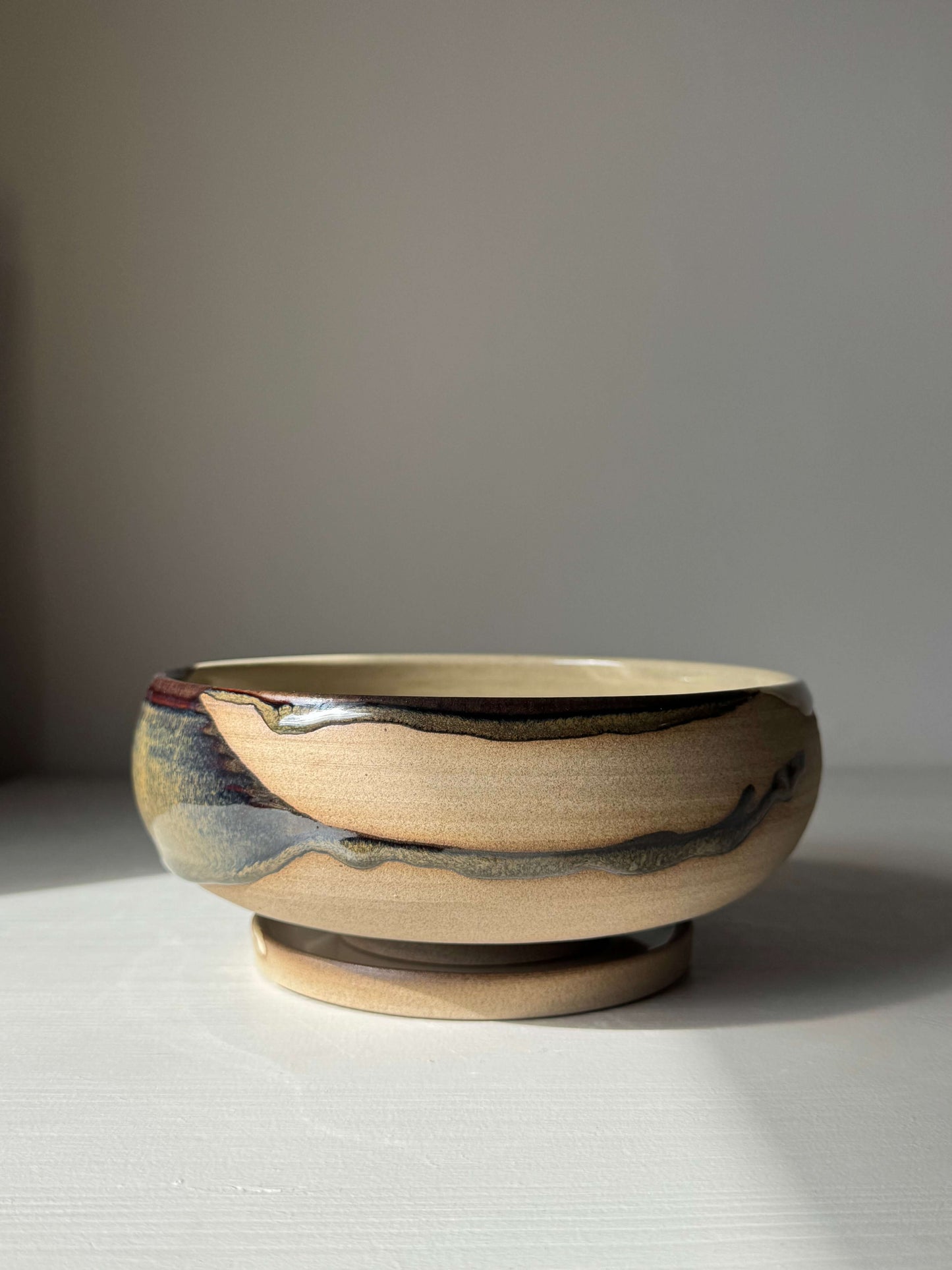 Handmade ceramic Rounded Berry Bowl - Inyo Series with drip plate, featuring glossy tenmoku and clear glaze finish.