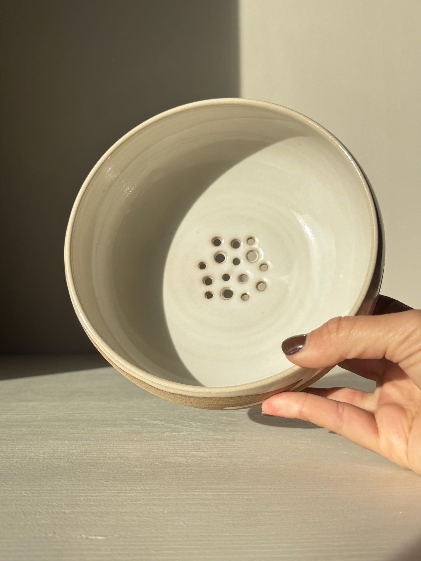 Rounded Berry Bowl - Yuki with soft white glaze and drainage holes, perfect for rinsing fresh fruits and herbs.