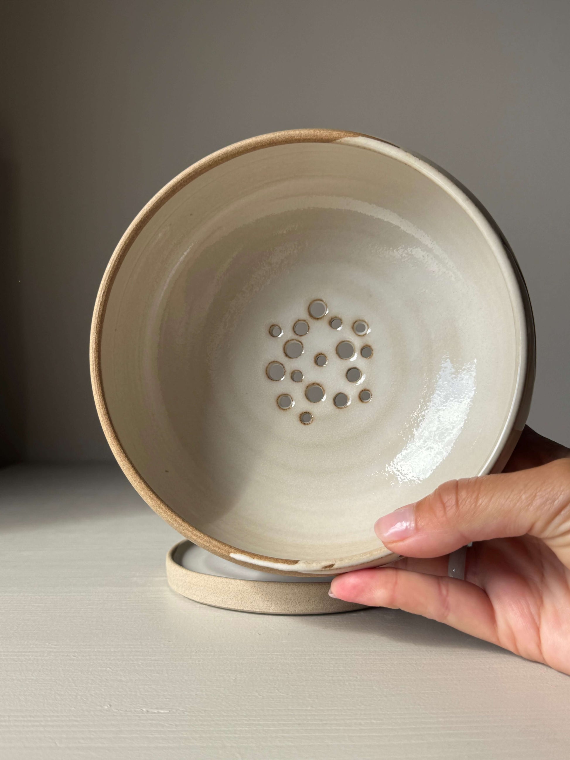 Handmade ceramic Rounded Berry Bowl - Yuki with white glaze and toffee clay for rinsing fruit and herbs, includes a matching drip plate.