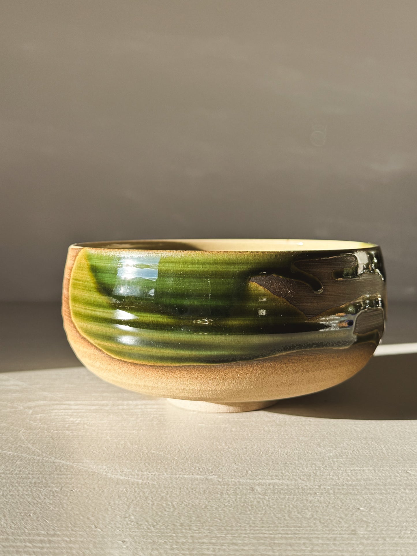 Rounded Breakfast Bowl – Mori with a glossy green glaze and warm toffee clay, perfect for granola, soup, or rice.